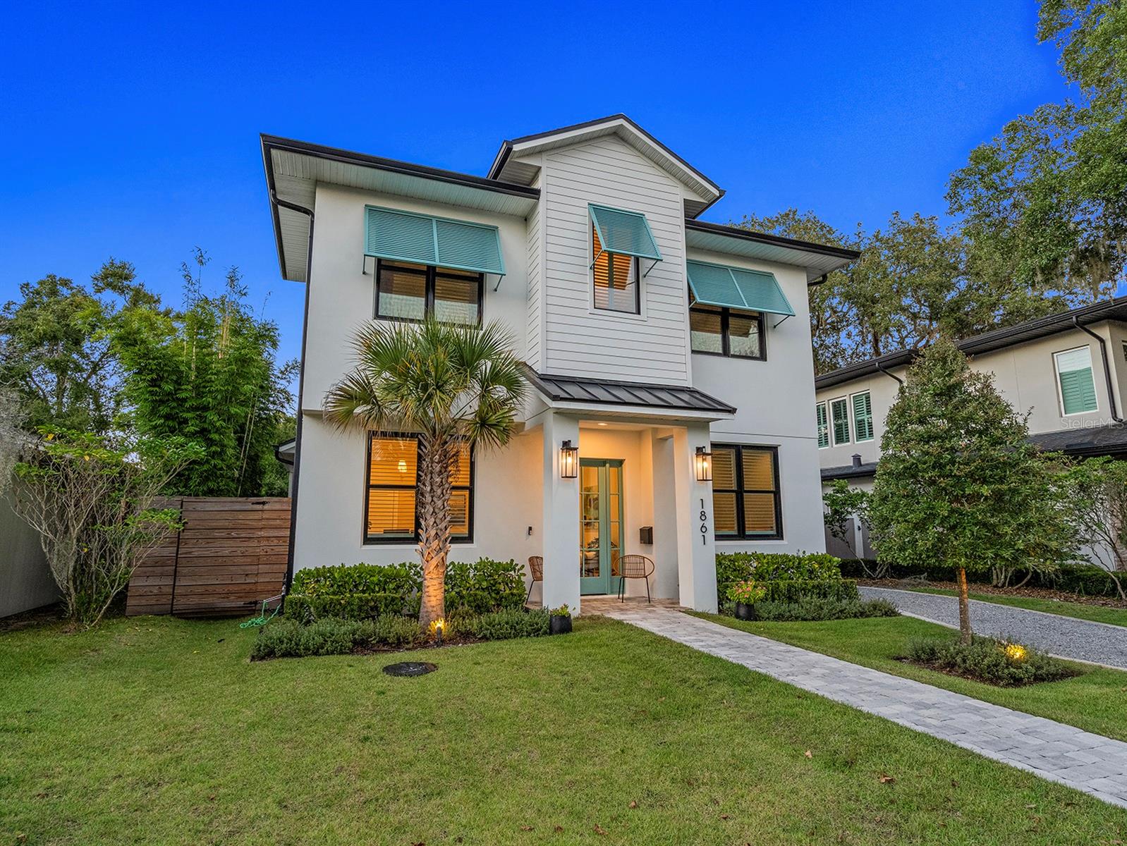 Built by Meridian Homes in 2023, this newer construction, five-bedroom, five full- and two half-bath residence combines timeless coastal architecture with a fresh, modern sensibility. Designed by Lauren Ayers Interiors, every detail of this home exudes style, sophistication and livable refinement. A charming façade and manicured landscaping create picturesque curb appeal, welcoming you into a beautifully curated interior featuring wide-plank hardwood floors, custom cabinetry by Monarch Kitchens & Baths and designer finishes throughout. A light-filled office with a wood-paneled accent wall and walk-in closet sits in front of the home, offering a space for work or study. The spacious kitchen is a chef’s dream, anchored by a large center island with seating, Wolf range, GE Café double oven/microwave, and undercounter beverage fridge, and opens seamlessly to the inviting living room with gas fireplace and custom built-ins. The dining area, adorned with a Rifle Paper Co. accent wall, features sliding glass doors that open to the covered lanai, extending the living space outdoors. The private primary suite offers direct access to the lanai, a large walk-in closet, and a spa-inspired bath with an oversized glass shower. A guest suite with en-suite bath is also on the first floor, along with a powder bath and spacious laundry room. Upstairs, a family/bonus room provides flexibility for a media space, study area or playroom. Three additional bedroom suites, each with private en-suite baths and generous closets, complete the second floor. The covered lanai serves as an elegant outdoor retreat overlooking the heated saltwater pool and spa. The detached two-car garage has been thoughtfully extended to include a fully equipped summer kitchen with built-in grill, vent hood, sink, undercounter fridge, pool bath and outdoor shower area. The driveway with automatic gate adds privacy and convenience. Additional highlights include custom wood shutters on all windows, built-in surround sound and whole-house network, and floor-to-ceiling tile in every bath. A short distance to Lakemont Elementary and just minutes from Park Avenue and downtown Winter Park, this home offers an unmatched combination of design, comfort and sophistication, near the best dining, shopping and recreation Central Florida has to offer.