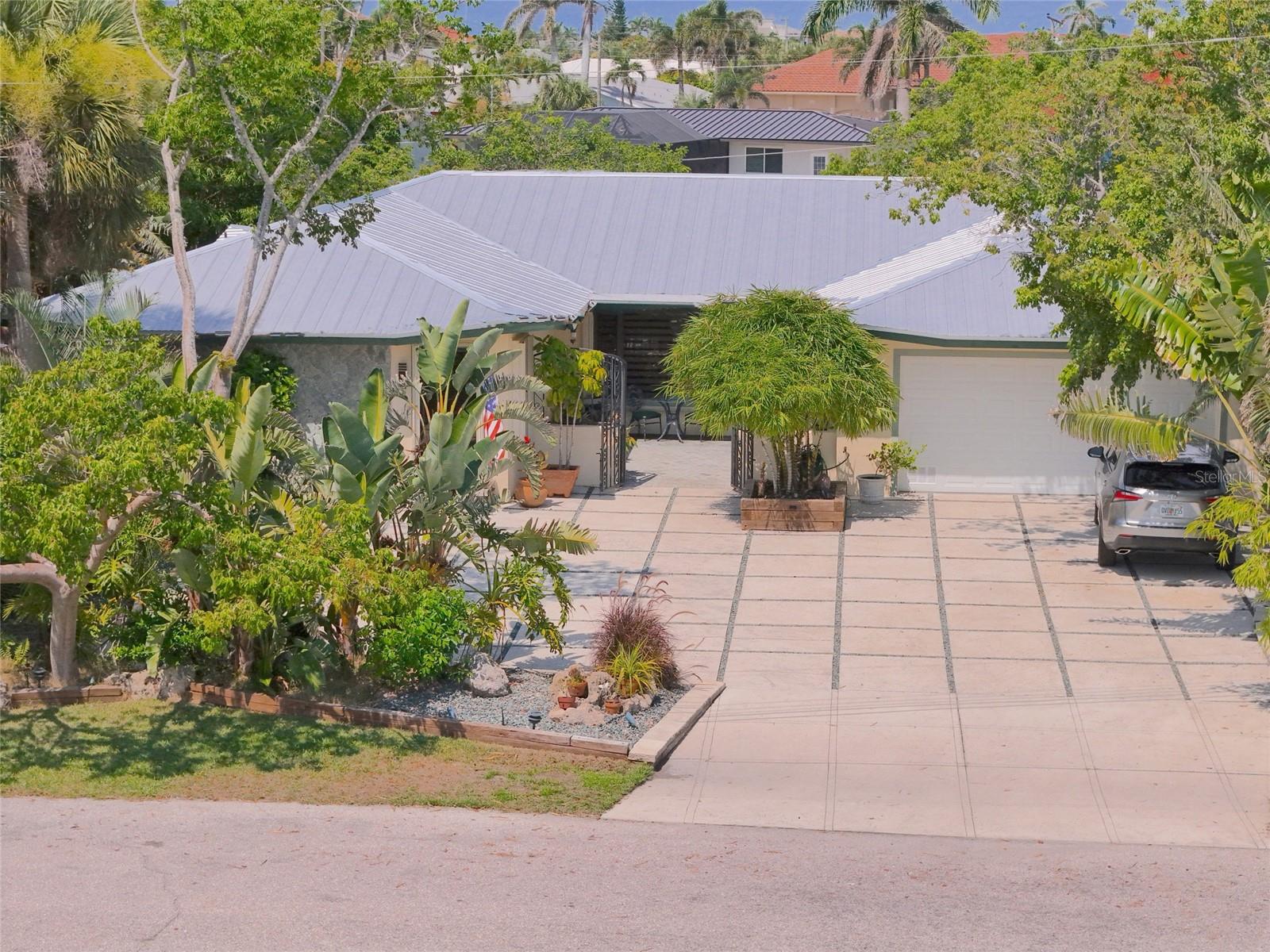 DIRECT GULF ACCESS – NO POOL TO MAINTAIN! Boaters, this is the one. If you’ve been searching for direct sailboat access without the hassle of pool upkeep, this home is perfect. Priced over $80/sqft. less than comparable Gulf access homes in PGI, it delivers incredible value and premium waterfront features—plus more time to spend on the water, not on pool maintenance. Located at the end of a quiet cul-de-sac in one of Punta Gorda Isles’ most walkable and peaceful neighborhoods, this property offers zero-bridge access and just 6 minutes to open water in Charlotte Harbor, leading straight to the Gulf of America. Waterfront Highlights **102' city-maintained seawall ** 65' concrete dock with Slide Moors & 10,000 lb. boat lift (dockside water & electric) ** Wide canal with deep-water turning basin — yacht-ready ** Galvanized metal roof (2022) ** Prepaid, transferrable flood insurance through 2027 ** Inside Features ** Nearly 2,800 sq. ft. of coastal-inspired living space includes ** Open-concept gourmet kitchen with Jen-Air double oven, induction cooktop & large island ** French doors opening to a tropical backyard with fruit trees, orchids & a bubbling jacuzzi overlooking the water ** Split-bedroom layout for privacy, including a master suite with new wood-look ceramic tile, walk-in closet ** Tile flooring throughout, crown molding, & custom solid-wood closet organizers ** Impact-rated garage door, accordion shutters, & oversized laundry room. Lifestyle & Location - Catch world-class tarpon, snook, and redfish from your backyard, or spot dolphins and manatees cruising by. Moments from the Yacht Club, Fishermen’s Village, Gilchrist Park, and downtown Punta Gorda, this is a rare opportunity to own a low-maintenance, boater’s dream home in one of PGI’s best boating locations. 155 Donna Court — No Pool, No Worries. Just Pure Waterfront Living.