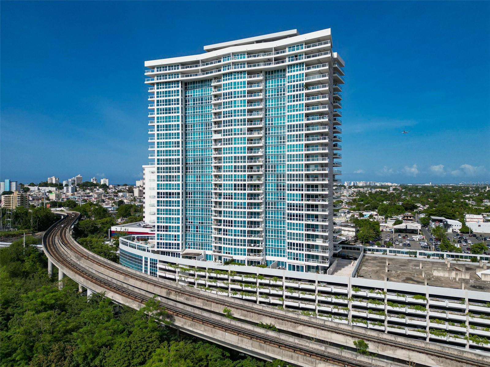 Discover sophisticated urban living in this professionally decorated luxury apartment at the prestigious AquaBlue Condominium, located in the heart of Hato Rey's bustling financial district. This elegantly appointed residence showcases impeccable design and premium finishes throughout, creating an atmosphere of refined comfort and contemporary style.
Premium Building Amenities:
Full building generator ensuring uninterrupted power
24/7 professional security for peace of mind
Convenient visitor parking
Resort-style swimming pool
State-of-the-art fitness center
Multi-purpose activity room for entertaining
Beautifully landscaped common areas
Apartment Features:
This thoughtfully designed unit boasts professional interior decoration with carefully curated furnishings and high-end finishes. Every detail has been meticulously selected to create a harmonious blend of luxury and functionality, offering an elevated living experience from the moment you walk through the door.