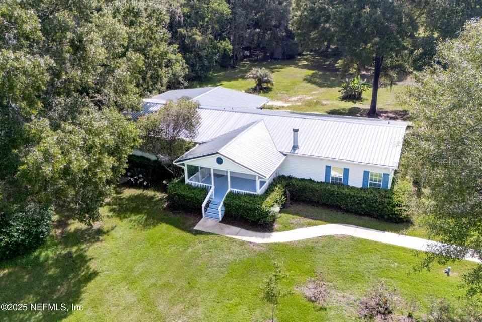 Beautifully updated 5BR/3BA home on +/-12 acres full of gorgeous trees with a stocked pond and gazebo. Approx. 3,800 sq ft under roof with a wood-burning fireplace, office, fresh paint, updated kitchen, new flooring, new roof and spacious living areas. Enjoy a large front and back porch, tons of fruit trees, and a 30x32 carport, all in a serene country setting!