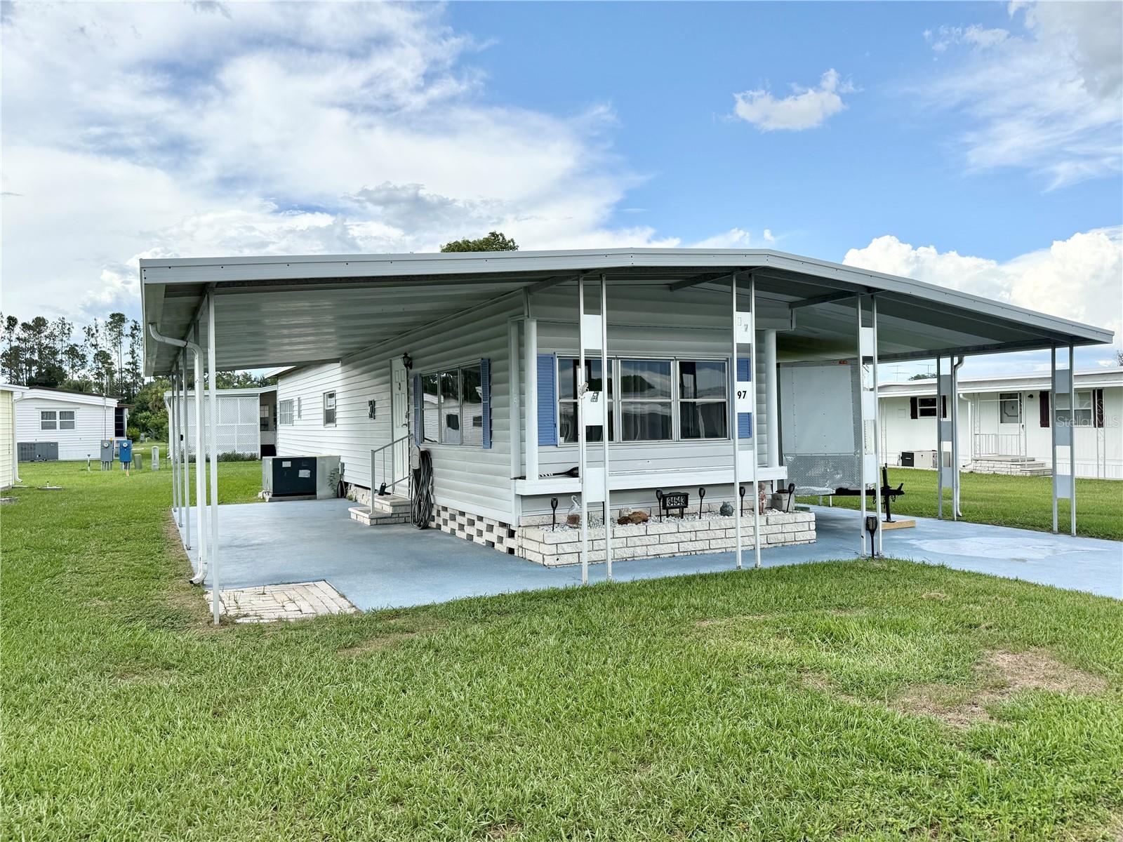 Welcome to Tippecanoe Village, a vibrant 55+ community where you own the land and enjoy a low HOA of just $80/month. HOA includes water, sewer, trash, a community pool, shuffleboard courts, clubhouse, and RV/boat parking. This move-in ready home has been thoughtfully updated with new subfloors, carpeting, laminate flooring, and drywall throughout. The kitchen features two lazy Susans, pull-out pantry shelves, remote under-counter lighting, and new refrigerator and microwave—designed for both convenience and functionality. Stylish new fixtures and window treatments add a fresh, modern touch, and the home is partially furnished, clean, and freshly painted. Enjoy the outdoors year-round in the glassed-in patio complete with its own window unit—perfect for relaxing or entertaining. You'll also appreciate the large utility room, which offers abundant storage, a workbench, and an included washer and dryer. Located in a golf cart-friendly neighborhood, you're just minutes from local shopping, restaurants, and entertainment. Tippecanoe Village offers the perfect blend of peaceful living and active lifestyle. Don’t miss your chance to own this beautifully updated home in one of the area’s most desirable 55+ communities!