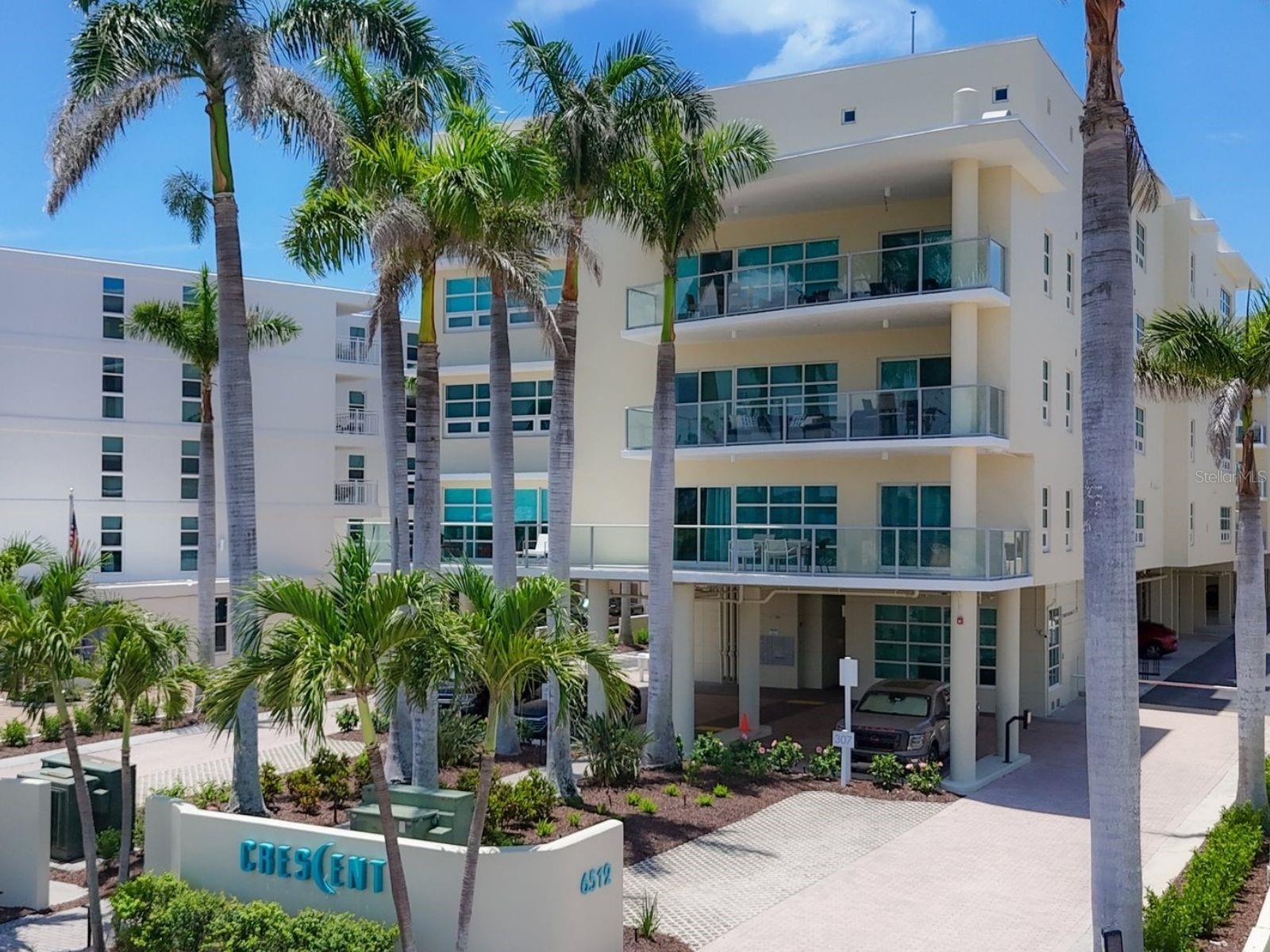 This rare and exceptional turnkey Siesta Key residence offers an unparalleled blend of space, style, and sweeping Gulf views. Spanning nearly 2,000 square feet, this 3-bedroom, 2.5-bath coastal retreat features two expansive terraces—one overlooking the serene elevated pool and spa area, and the other offering unobstructed sunset vistas across the Gulf. Each of the three bedrooms enjoys private balcony access via sliding glass doors, creating a seamless indoor-outdoor living experience.
Designed with a modern coastal aesthetic, the interior features full-thickness bamboo flooring in the main living areas, premium custom cabinetry, and sleek quartz countertops. Soaring 11.5-foot ceilings and clerestory windows with remote-controlled shades enhance the home’s light-filled, airy ambiance. The gourmet kitchen is equipped with top-of-the-line GE appliances, bar-height seating, and a pass-through window that frames the Gulf beyond.
The open-concept living and dining areas are ideal for entertaining or quiet reflection, anchored by a Gulf-facing terrace and thoughtfully appointed with a Stressless reclining sofa and captain’s chairs—all perfectly positioned to take in the view. The spacious primary suite offers high ceilings, expansive windows with Gulf views, and blackout draperies for restful nights. The spa-style bath includes a multi-head oversized shower, a large vanity with quartz countertops, a dedicated makeup area, and tile flooring.
Two additional bedrooms are configured for comfort and versatility, including a dedicated office in the third bedroom with a Murphy bed. A host of upgrades includes a Schlage Smart Entry Lock, Arlo security camera system, hardwired mesh network for seamless connectivity, a deck-mounted hot water dispenser, and an 80-gallon hot water heater with recirculating system. Additional conveniences include two dedicated parking spaces located on the first floor under the building and an air-conditioned storage cage (#20) on the fifth floor.
Crescent offers an elevated beachfront lifestyle with private, direct access to Crescent Beach. The community is meticulously maintained, with newly renovated pools—including an elevated second-floor spa and a completed beachside pool and hot tub—fresh exterior painting, new landscaping, and a host of upscale amenities including a fitness center, social room, upgraded security system, and onsite manager. Ideally situated just off Stickney Point Bridge, this residence offers effortless access to Sarasota’s renowned dining, shopping, and cultural attractions. With Siesta Beach just steps away—recently named the No. 1 beach in America by Tripadvisor—this property captures the essence of Gulf-front living, whether as a full-time home, luxurious getaway, or investment opportunity.