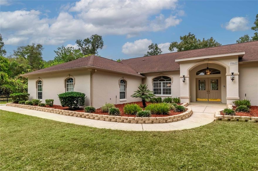 Nestled at the cul-de-sac end of a tranquil street within the serene Timberwood deed-restricted community, this captivating property not only boasts abundant curb appeal but also offers an incredibly convenient location. Situated on just under an acre, the residence showcases expansive yards, well-established landscaping, and a border of mature trees that not only enhance privacy but also contribute to its aesthetic charm. The residence, spanning over 2,600 sq.ft., exudes a light and airy ambiance. Featuring 4 bedrooms and 2.5 baths, the home offers tall cathedral ceilings and wood-look laminate flooring throughout the shared spaces. Plush carpeting and elegant tile enhance the bedrooms and bathrooms, respectively. Artfully designed recessed areas, including two in the entryway with top-down lighting, contribute to the home's distinctive character. Entertaining is made effortless with the inclusion of a formal dining room off the entryway, complementing the nearby eat-in kitchen. The kitchen boasts expansive granite countertops, abundant cabinet storage, soft close drawers, stainless steel appliances, a tiled backsplash, skylight, and sizable breakfast bars, making it a comprehensive space for those who enjoy cooking. The adjacent breakfast nook, with access to the back patio, offers a delightful space for casual meals. The living area is appointed with a built-in entertainment area and three arched windows adorned with plantation shutters. Each bedroom is a comfortable retreat, with the master suite standing out with its extra-large layout, patio access, dual walk-in closets with shelving systems, and a private en-suite bathroom featuring dual vanities, a spacious walk-in shower, and a jetted tub. The property's outdoor spaces are equally impressive, with a screened patio surrounding the sparkling heated pool. A covered area provides the option for shaded seating, while the outdoor shower makes rinsing off before or after a quick swim easy. Beyond, the backyard showcases a shuffleboard court and a full-sized shed for additional storage options. The attached 3.5-car garage, complete with a workshop and additional sink, offers a versatile space for private work, hobbies, or crafts. Conveniently located just minutes from the State Road 200 corridor, this meticulously maintained property provides easy access to Market Street at Heath Brook's shopping and dining (1.9 miles), Publix (3 miles), and I-75 (1.9 miles), offering diverse exploration options for residents looking to make the most of Central Florida's year-round sunshine!