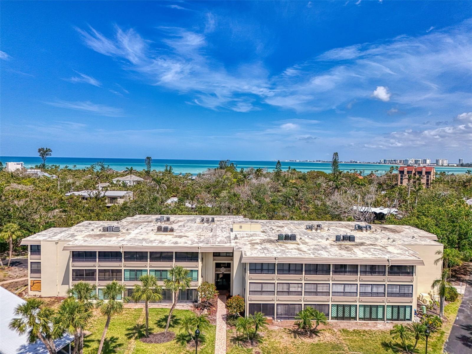 Completely renovated from top to bottom, this stunning 2-bedroom, 2-bath condo is located in the highly desirable Whispering Sands community on Siesta Key. Designed with a modern coastal aesthetic, the open-concept layout features luxury vinyl plank flooring, 5-inch baseboards, and all-new 2-panel and louvered doors throughout. The air conditioning ducts in the living areas have been rerouted through the guest bedroom closet and enclosed in a custom soffit for a clean finish. The gourmet kitchen is equipped with quartz countertops, stainless steel appliances, custom cabinetry, and a stylish backsplash. A designated “coffee bar” area, enhanced by floating shelves with LED strip lighting, adds charm and functionality, while additional under-cabinet lighting creates a warm, inviting ambiance—perfect for both everyday living and entertaining. The spacious primary suite offers a walk-in closet and a beautifully updated ensuite bathroom with premium finishes. A well-sized guest bedroom and a second full bath with a walk-in shower add to the comfort and convenience. Whispering Sands is a gated 55+ community offering a full suite of resort-style amenities, including 800 feet of private deeded beach access on world-renowned Siesta Key Beach, two heated pools, a fitness center/clubhouse (under renovation), and shuffleboard courts. Just a short walk to Siesta Key Village, you'll have easy access to restaurants, shops, and nightlife. HOA includes water, sewer, trash, and cable. Assigned covered parking. Perfect as a full-time home, vacation getaway, or investment property—this move-in ready condo has it all.