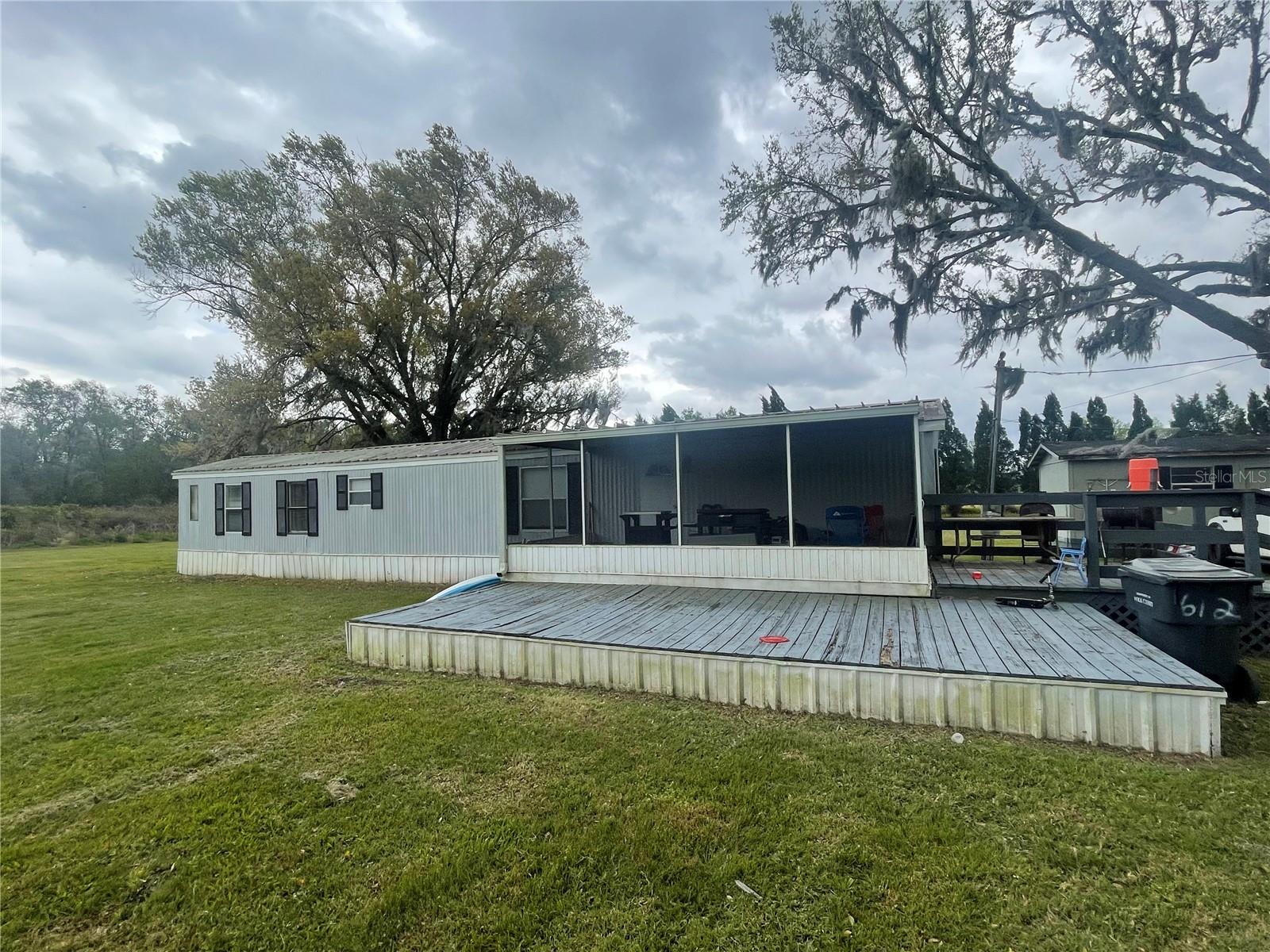 FL living at an affordable price or great investment property! This 2BD/2BA home is situated on 0.94 acres. Short distance to all shopping, schools, medical facilities, and restaurants. Make this your new winter retreat or year around home. Call today, don't miss this great investment opportunity.