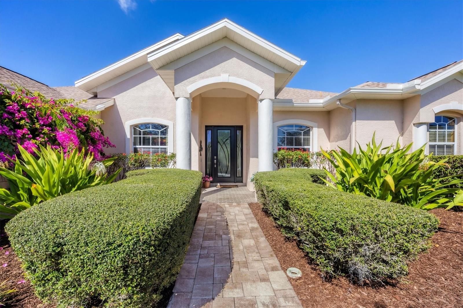 Nestled on a peaceful street in the coveted Riverwalk Hammock community of Lakewood Ranch, this exceptional residence offers the perfect blend of privacy and serene lake and preserve views. Thoughtfully designed with soaring high ceilings, expansive room sizes, and an open-concept floor plan, this home seamlessly blends indoor and outdoor living with large banks of windows and sliding glass doors. Recent upgrades enhance both comfort and convenience, including a natural gas generator, a new paver driveway, walkway, and lanai, a newer roof, an electric-powered awning, motion-activated security lights, a new hot water heater, a new pool heater, and elegant wood flooring. Just beyond the welcoming foyer, the spacious living and dining areas create a warm and inviting atmosphere, ideal for entertaining. The kitchen features rich wood cabinetry, stainless steel appliances, stone countertops, and bar seating that flows effortlessly into the family room. Step outside to your private screened-in outdoor retreat, accessible from the living room, family room, and primary suite. With covered and uncovered seating areas and a sparkling heated pool, this is the ultimate space for relaxation and entertaining. The primary suite is a tranquil escape, boasting a cozy sitting area, a walk-in closet, and a spa-like ensuite bathroom. On the opposite side of the home, two generously sized bedrooms share a well-appointed bathroom. A dedicated office, a spacious laundry room, and a two-car garage complete this remarkable home. Located in the heart of Lakewood Ranch, this home places you just minutes from UTC Mall, Lakewood Ranch Main Street, Waterside Place, scenic walking and biking trails, world-class golf courses, top-rated schools, dog parks, and more. Experience the best of Florida living in this stunning home—schedule your private showing today!