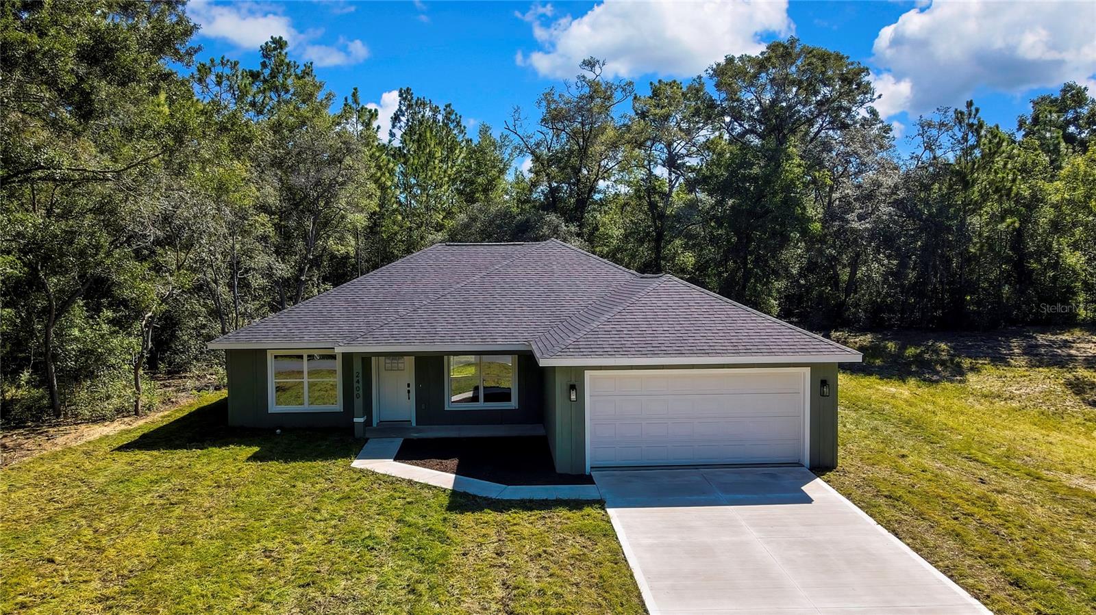 This beautiful 3-bedroom, 2-bathroom home with a 2-car garage is perfectly situated on nearly a quarter-acre lot with no side neighbor, offering added privacy and space. Inside, you’ll find an open split floor plan featuring quartz countertop, soft-close wood cabinets, waterproof luxury vinyl plank flooring, and stainless-steel appliances. Built with energy efficiency in mind, the home includes foam insulation and a 30-year architectural roof warranty for peace of mind. Enjoy relaxing on your covered front porch and take advantage of the convenient location—right across the street from the Withlacoochee State Trail and just minutes from Rainbow River. Only 20 minutes to Crystal River with direct access to the Gulf. This is Florida living at its best!