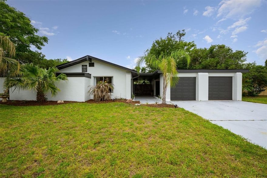 Beautifully remodeled mid-century modern home located on the very first street developed in Palm Coast — historic Casper Drive, named after golf legend Billy Casper. Originally the sole access road to the Palm Harbor Golf Course, this unique property blends timeless character with modern updates. Features include stainless steel appliances, solid surface quartz countertops, and an inviting eat-in kitchen. The flexible floor plan is ideal for dual primary suites and offers an oversized family room plus separate living and dining areas. Enjoy the expansive 9x50 Florida room with electricity, overlooking a private large wood-fenced backyard. Additional highlights include a two-car garage and an unbeatable location with room for a pool, walking distance to golfing, 4 minutes to boat marina, and a 7 min drive to the beach.