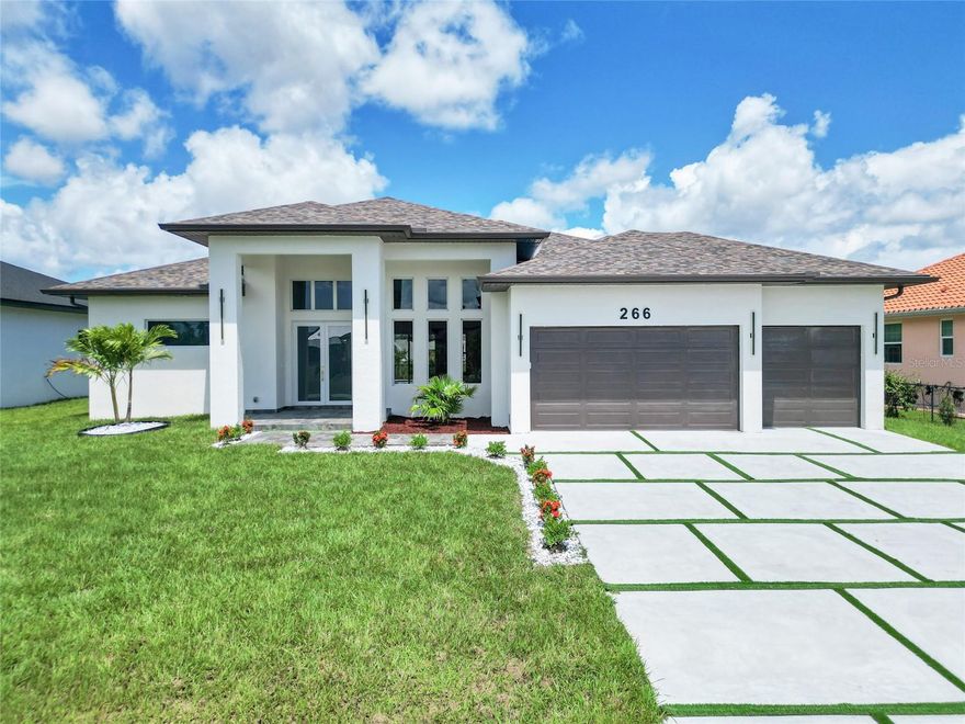 This newly built home in Port Charlotte, FL, is a luxury gem, perfect for those seeking a modern property in one of the city's best neighborhoods, specifically in the exclusive Rotonda West area. The house is located in a community that has 4 golf courses. Designed with comfort and style in mind, this property features 3 spacious bedrooms and 3 bathrooms, making it the ideal home for families or those who enjoy hosting guests. Every detail of this home has been carefully crafted with the highest quality materials. Large-format porcelain floors add elegance and continuity to the spaces, while high ceilings create a sense of openness and brightness. The kitchen is a true highlight, equipped with state-of-the-art stainless steel appliances that perfectly complement the modern finishes. The contemporary cabinetry and central island provide both functionality and aesthetics. The three bathrooms are fitted with modern fixtures, and one of them connects directly to the pool area. The property boasts a stunning designer pool with an integrated jacuzzi, set in a spacious backyard. With a canal at the rear of the home, residents will enjoy peaceful, serene water views. Additionally, the location in Rotonda West is one of the most desirable in Port Charlotte, offering privacy, tranquility, and a high-quality residential environment. The home includes a large 3-car garage, providing ample and secure space for vehicles and additional storage. It also features an irrigation system to maintain the landscaping. In a region like Port Charlotte, impact windows are an essential feature for security and protection against weather events, ensuring that the home is not only beautiful but also resilient. With a modern design, advanced technology, and the highest-quality materials, this home is a true luxury retreat in one of the most exclusive areas of the region. Ideal for those seeking comfort, style, and the best location in Southwest Florida.
