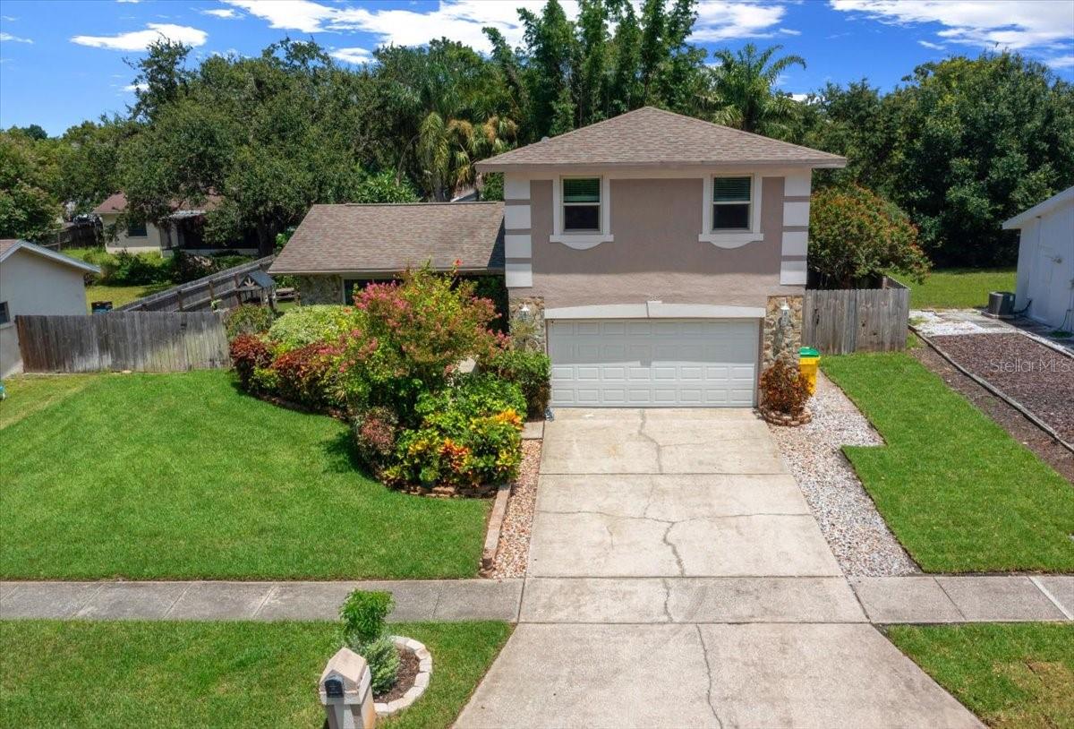 Welcome to this beautifully updated two-story, 4-bedroom, 2.5-bath home, nestled in a no-HOA community just a short drive to the beach. Located outside of evacuation zones and with no known history of flooding, this home also includes a generator backflow hookup, to keep it as practical as it is charming. The bedrooms are located upstairs—including the primary suite, which features new LVP flooring, an en suite bathroom, and access to an upper-level deck great for morning coffee or relaxing under the stars. The remaining bedrooms showcase ultra-plush carpeting and a comfortable retreat for family, guests or an office. You’ll find all three of the bathrooms have been recently renovated, including the primary walk in closet. Downstairs, enjoy brand new flooring throughout the living room, kitchen, and dining area. The living space is open and bright with large book-end windows, while the dining room offers its own dedicated space with natural light streaming in from the impact-resistant sliding glass doors. The fully fenced backyard is a true outdoor oasis. A turf-lined side yard creates a play friendly space, while a separate grassy area is great for pets. A beautifully maintained waterfall pond provides a setting for possibly koi, turtles, or fish. An animal enclosure, currently home to tortoises, is prepped with irrigation and can easily be converted to a garden or sodded green space. Two large storage sheds would be useful for tools, toys, or seasonal items.
Additional features include impact-resistant windows, two AC units for zoned climate control, a spacious two-car garage, an enclosed laundry room with outdoor access, and a charming screened-in front porch that adds a sense of seclusion.
This thoughtfully maintained home offers the perfect blend of modern upgrades, flexible outdoor living, and coastal proximity—with no HOA restrictions to hold you back.
