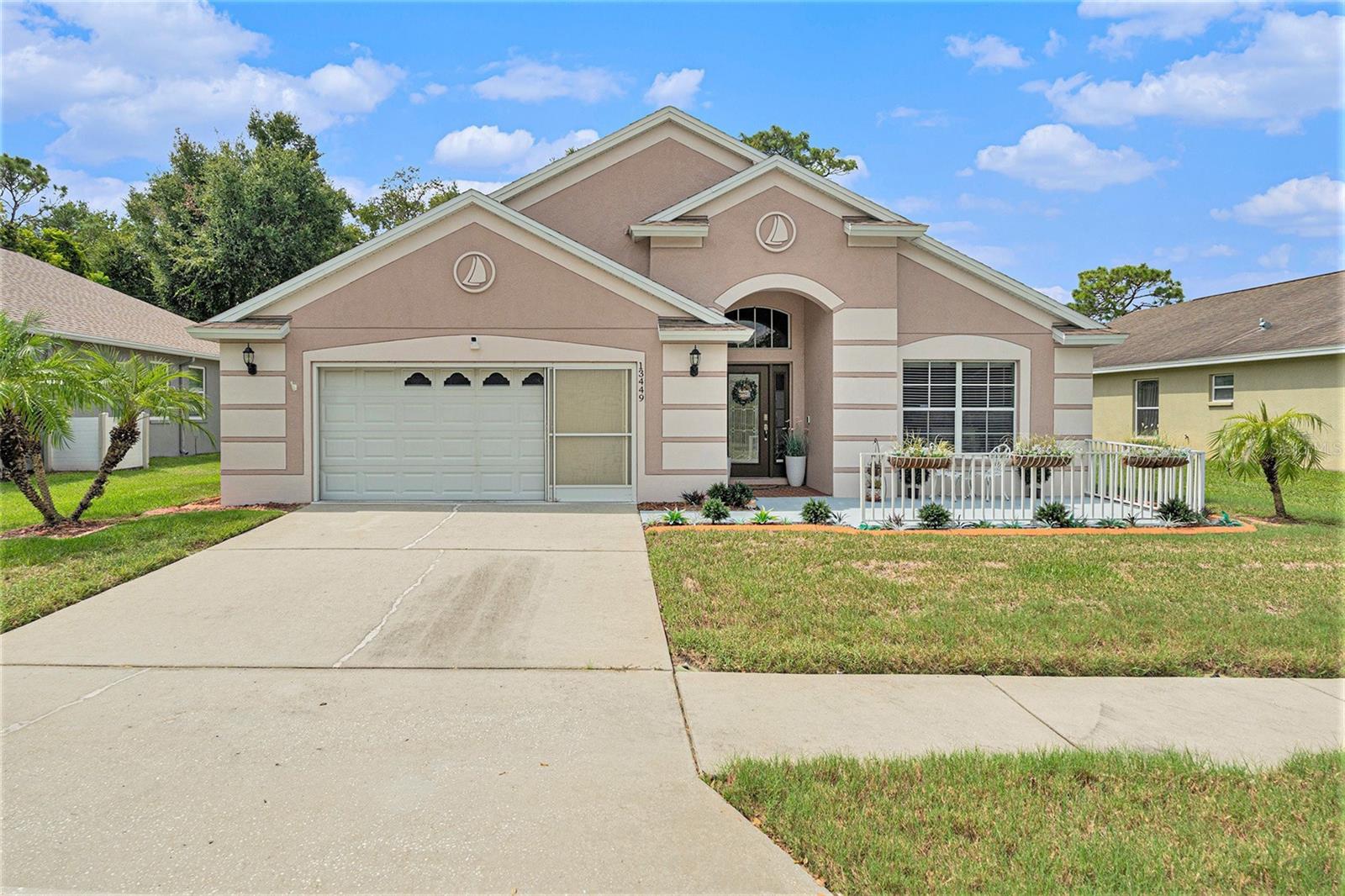 Come live in Paradise! This gorgeous ONE-STORY home is located in the desirable gated community of Reserve at Meadow Oak right in the heart of Hudson. Home Sweet Home! This amazing home offers 4 bedrooms, 2 full bathrooms with a kitchen that opens to a large living room. Once inside you will be greeted by an amazing open floor plan with high ceilings and open spaces. Welcome to the kitchen where sweet memories are being made. The kitchen is seasoned with love and is perfect for entertaining your guests, featuring lots of cabinets and extended counterspace. The kitchen is the heart of the home. The fondest memories are made when gathered around the table. Enjoy hosting casual dinners with the family or extravagant dinners in the dining area open to the living room with amazing views to the backyard. This home is full of endless possibilities. Master suite offers plenty of room with a tranquil view of the fenced in backyard. Master bathroom offers a garden tub and dual vanity sinks with lots of storage. A secondary bedroom is located right off the master suite, providing the perfect setup for a nursery, home office, or added convenience for little ones. Life is too short to fold fitted sheets but convenient in the large laundry room with plenty of storage. The garage has plenty of space so bring your toys, bikes and extra vehicles to store in the 2 car garage. Time spent on the screen lanai is time well spent. Relax and enjoy as there will be a lot of sipping, grilling and chilling with an amazing extended covered lanai overlooking the peaceful fully fenced backyard. Located within a gated community, residents enjoy a lifestyle filled with amenities, including a golf course, clubhouse, swimming pool, tennis courts, and shuffleboard. The neighborhood also offers a full calendar of activities, making it easy to stay active and social. Conveniently close to dining, shopping, and just 45 minutes from the beautiful Tampa and Clearwater beaches, this community offers the perfect blend of relaxation and convenience.