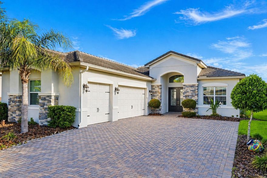 One or more photo(s) has been virtually staged. Welcome to the highly sought-after Julia model by GL Homes, located in the sought-after gated community of The Ridge at Wiregrass Ranch. This beautifully upgraded residence blends modern elegance with thoughtful design, offering true Florida resort-style living within a 24-hour guard-gated neighborhood. Step through grand double doors into a bright, open foyer with soaring ceilings that immediately create a sense of space and sophistication, leading into an expansive living area that is warm and inviting, perfect for both everyday living and effortless entertaining. This home features 4 bedrooms, 3 bathrooms, and a 3-car garage, offering a functional layout that balances privacy and connection, with all 3 bedrooms upgraded with brand-new vinyl flooring for a clean, modern look and lasting durability. At the heart of the home, the gourmet kitchen impresses with a gas cooktop, range hood, granite countertops, and serene water views that make every moment in the kitchen a pleasure. The primary suite serves as a peaceful retreat, showcasing tranquil pond views, dual walk-in closets, and a spa-inspired en-suite bath complete with a soaking tub, walk-in shower, and dual vanities. Enjoy outdoor living at its finest with an expanded brick-paver driveway, ideal for larger vehicles, and an oversized screened-in lanai overlooking a picturesque water-view backyard. Residents of The Ridge at Wiregrass Ranch enjoy access to an impressive 11,691-square-foot clubhouse set on 5.5 acres, featuring a resort-style pool, a water play area with a slide, a 24-hour fitness center, an aerobics and dance studio, an indoor sports court, four clay tennis courts, indoor and outdoor basketball courts, a shaded playground, and an open playfield. The HOA provides a truly maintenance-free lifestyle, including lawn care, fertilization, mulching, exterior pest control, palm trimming, and full-time gated security. Ideally located near I-75 and I-275, this home offers convenient access to The Shops at Wiregrass, Tampa Premium Outlets, Wiregrass Ranch Sports Campus, three nearby hospitals, as well as top-rated schools, dining, and entertainment. Discover the perfect blend of luxury, comfort, and community at The Ridge at Wiregrass Ranch, where your dream home and the Florida lifestyle come together seamlessly. Schedule your private showing today.