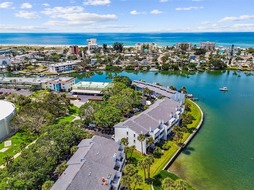 Welcome to your own slice of waterfront paradise on Isle of Capri! This 2-bedroom, 2.5-bathroom townhome-style condo with a 1-car garage offers the ease of condo living with the comfort and privacy of a single-family home. Nestled on the sparkling Boca Ciega Bay of the Intracoastal Waterway, you’ll enjoy three private patios overlooking the water, one on each floor, perfect for morning coffee, evening unwinding, or watching dolphins play just outside your door. Inside, a bright and inviting layout is designed for everyday comfort. The main floor features an open floor plan where the kitchen, dining, and living areas all showcase breathtaking water views. Upstairs you'll find both bedrooms and two full bathrooms. The primary suite showcases the home’s most stunning views, with a private top-floor patio overlooking the turquoise waters.This home has been thoughtfully upgraded with NEW hurricane-rated windows and sliders ($42k upgrade). Brand-new AC systems include two full-sized units (2024) and a mini split in the bonus room (2025). The garage level has epoxy flooring, removable waterproof TrustCore drywall panels, and new fire-rated doors. Additional updates include new luxury vinyl plank flooring upstairs, updated lighting and ceiling fans throughout, and a new electrical panel (2023). Flood insurance is fully paid through 11/27/2027 with FEMA for added peace of mind. The community features a heated pool, kayak launch, seawall, and boat slips available for rent - perfect for water lovers. Just steps away, Roselli Park offers tennis and pickleball courts, a playground, dog park, and walking path. From your front door, the Gulf of Mexico and the sugar-white sands of Treasure Island are only moments away, perfect for sunset walks and beach days. Don’t miss your chance at this waterfront gem!