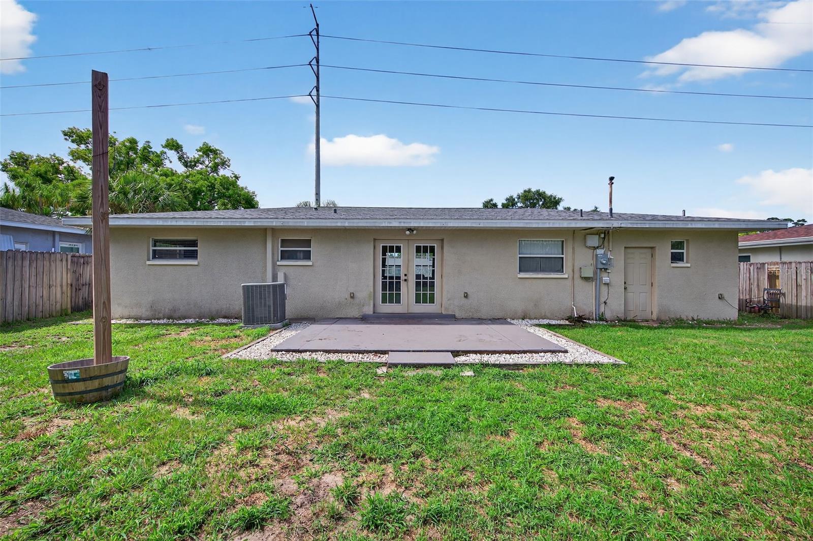 This 3 bedroom, 2 bathroom, mid-century home in unincorporated Pinellas County is just minutes to Gulf beaches, shopping, dining, and parks. This home is Airbnb/short-term rental friendly, perfect for anyone looking to make extra income! The open floor plan features an updated kitchen with stainless steel appliances, granite countertops, and a large island flowing into spacious living areas. A private third bedroom with bath has its own entrance, perfect for guests or a home office. French doors lead to a covered patio and a huge fenced backyard with plenty of room for a pool. No HOA, no flood insurance. New A/C (2022) and roof (2019) make this home move-in ready!