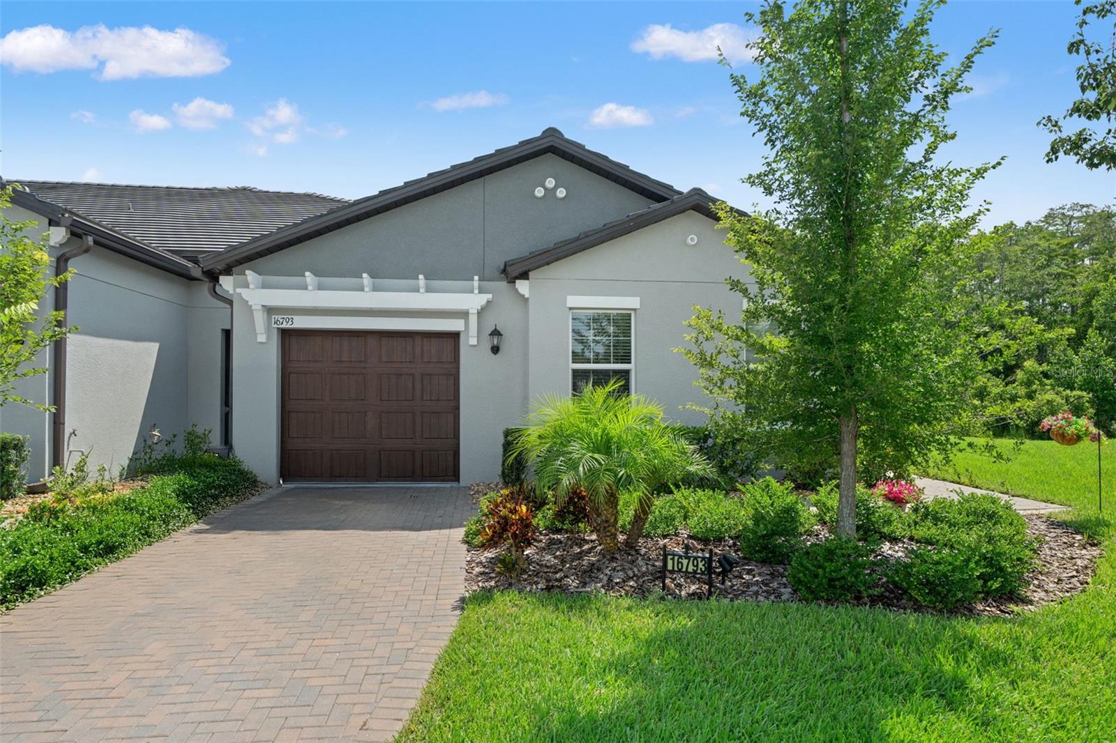 MOTIVATED SELLER! Meticulously maintained and ready for new owners! Step into this immaculate home and only bring your toothbrush. Welcome to The Angeline Community in Land O Lakes! This home features 2 spacious bedrooms within a split floorplan, great for privacy throughout the home, as well as a flex room that can be used as a media room, office, or anything you can imagine! Once you pull up to the home you're greeted by immaculate curb appeal, with a very welcoming garden leading to your side entrance, this one is a corner unit, which means you get a gorgeous view both when entering and leaving your home, but we'll get to that later! Opening the front door you'll notice ALL OF THE NATURAL LIGHT, as well as the very spacious kitchen, featuring a large island and plenty of cabinet space! With a convenient floorplan and very accessible, his home is easy to entertain and hang out with guests, with the kitchen being nice and open to your living room and dining room! Ready for Sunday football or a family movie night? Maybe just having guests over? This one makes it easy and with a spacious patio off of the living room, sunny days with the BBQ are so easy! This home also features a very classic touch with crown molding throughout the kitchen and your living areas! Let's get to the primary bedroom, also featuring crown molding and an absolutely gorgeous view out back! What's better than waking up and seeing your beautiful yard out the window? The primary bathroom features dual sinks and a very tasteful backsplash for your walk in shower. Your walk in closet is a great size for any wardrobe, with an additional linen closet as well! Across the home, your media room is right off the dining room and kitchen. This room is perfect for gaming, can be used as a media room, an office, or anything else you can imagine! The opportunities are endless and with the large window, you'll be able to see all of the nature this home has to provide right out the large window! What seems like another primary suite, your second bedroom is across the home, with a generous size and the spare bathroom right off the room, making this even more convenient and easy to access. The community welcomes a resort style lifestyle, with a HUGE pool, outdoor bar, community events, a 12,000sqft+ clubhouse, restaurant, fitness center, and so much more! It also features bocce ball, pickleball, and shuffleboard courts, as well as walking trails and so many great features! With plenty to do and an immaculate home, this one is great option to settle down! In a great location, this one is conveniently located near shops and dining, and a quick drive to Tampa! Call today to schedule a private showing!