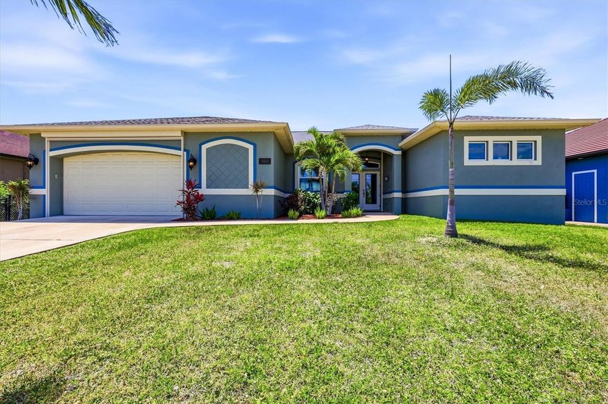Location, lifestyle, and the perfect place to call home — welcome to South Gulf Cove, one of Port Charlotte’s most desirable boating communities. This beautifully designed waterfront home immediately impresses with wide open views of the lanai and canal, showcased through zero corner sliders that disappear to blend indoor and outdoor living.The great room makes a striking first impression with a lovely, coffered ceiling trimmed in crown molding, and the adjoining dining area creates an elegant setting for gatherings. The kitchen is both functional and refined, offering true full wood cabinets, granite counters, stainless appliances, a walk in pantry, and an oversized breakfast bar ideal for prep and serving. Just off the kitchen, the spacious dinette — currently styled as a bonus sitting room — adds wonderful flexibility. Whether you prefer a cozy reading nook, office space, second conversation area, or traditional dining space, this multi function room adapts beautifully to your lifestyle while capturing peaceful water views. The primary suite is a retreat of its own with two oversized walk in closets and a spa inspired ensuite featuring a walk through shower with dual rainheads. The guest bedrooms are positioned in their own private wing and share a full guest bathroom, making this split plan ideal for hosting family and friends. Step outside to your private Florida oasis. The saltwater heated pool, multicolor LED lighting, and large screened lanai set the stage for relaxation and entertaining. A designated pool bath adds convenience for outdoor living. The fenced back yard keeps your pup safe, while the concrete seawall, dock, 10k boat lift, and side walkway make boating days effortless. You’ll love the friendly neighbors and the unbeatable access to Charlotte Harbor and the Gulf.
Practical features elevate peace of mind: • Extended garage with workshop space and remote control roll down bug screen • Impact glass plus additional storm panels for the sliders • Electric roll down hurricane shutters on front and rear • Wired surge protection • New roof (2023) • New saltwater generator (2025) • Fresh interior and exterior paint. This home blends craftsmanship, comfort, and coastal living in a community known for its waterways and welcoming atmosphere. Whether you’re entertaining, boating, or simply enjoying the view, this property delivers the full Florida experience.