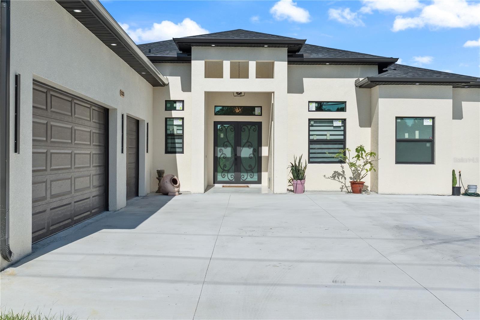 Welcome to this stunning brand-new 2025 custom-built home located in the heart of Port Charlotte, offering luxury living on a spacious half acre lot. This beautifully designed residence features four generously sized bedrooms, each with custom closets, and four full bathrooms showcasing elegant glass showers and modern LED-lighted mirrors. Two additional half baths provide convenience for guests and everyday living. Another plus is a versatile extra room, perfect for a home office, guest space, or hobby room.
As you step inside, you’ll be welcomed by an open-concept floor plan with soaring tray ceilings that add depth and sophistication throughout the home. The gourmet kitchen is a chef’s dream, boasting quartz countertops, rich wood cabinetry, high-end appliances, a large walk-in pantry, and a stylish wet bar perfect for entertaining. The expansive living and dining areas flow seamlessly, creating an ideal space for both relaxing and hosting.
A spacious laundry room offers functionality with ample storage, while the three-car garage provides plenty of room for vehicles, tools, or toys. Step outside and enjoy Florida living at its finest with a large saltwater pool, a fenced-in yard, and a setup ready for your custom outdoor kitchen.
This home is equipped with hurricane impact windows for peace of mind and an eight-camera security system for added safety. Every detail has been thoughtfully curated to blend modern elegance with everyday comfort, making this a truly exceptional property.
Located in a prime Port Charlotte neighborhood with convenient access to beaches, shopping, dining, and recreation, this home is the perfect combination of style, space, and security—ready for you to move in and make it your own.