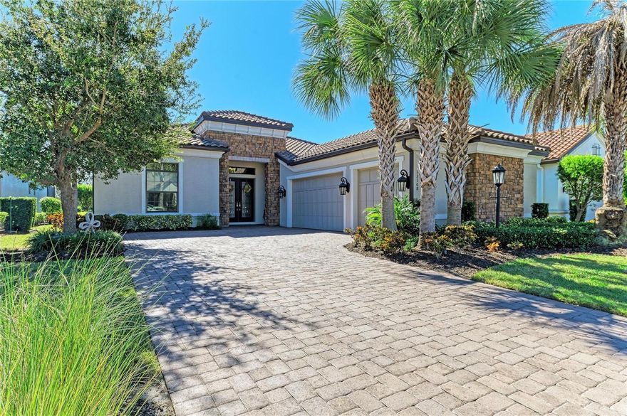 This stunning and rarely available Francesco model golf-deeded home is nestled within the prestigious golfing community of Esplanade in Lakewood Ranch. Upon entering through the beautifully upgraded glass doors, you are immediately greeted by a breathtaking “wow” factor as your view extends straight through to the picturesque lake. A coffered ceiling entryway opens into a spacious great room, seamlessly connecting the living spaces in an open floor plan.
The residence features three bedrooms and three-and-a-half bathrooms, with a host of special upgrades throughout. Notable features include crown molding in every room, soaring 15-foot ceilings, and eight-foot doors that add to the home’s grand feel. Two pocket sliders lead to the lanai and a private spool, while landscape screening ensures expansive water views and privacy. Hurricane-rated doors, shades and shutters are installed at both the front and back of the home. The Chef’s kitchen is designed for both function and beauty, boasting granite countertops, a large eat-in kitchen island, and 42-inch kitchen cabinets. The exterior showcases a beautiful stone façade, and the property includes a highly desirable three-car side-load garage. Esplanade is a private, membership-only golf course community, offering a world-class 18-hole championship course with an aqua range, as well as access to PGA professionals and lessons. The community’s extensive amenities include two fitness center, tennis courts, bocce, pickleball, two large heated lagoon-style pools and spas, a resistance pool, a Tiki bar, walking trails and dog park to name a few. The Culinary Center features the Barrel House Bistro/Bar, fine dining, event space and more  Conveniently located near Sarasota and Bradenton, residents enjoy easy access to shopping, beaches, and cultural events. Meticulously maintained, this home awaits your personal touch to become a special retreat within the amenity-rich community of Esplanade.