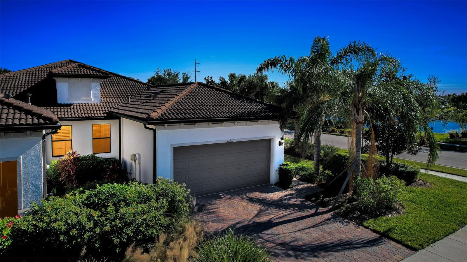 Resort-Style Living in Palmer Ranch! This move-in ready end-unit villa is light & bright with western water views. A true 3 bedroom & 2 full baths with a 2-car garage has been meticulously maintained by the original owners. Numerous upgrades were added to the design starting with whole house Impact Glass windows & slider, 8’ doors, & additional electrical features. This move-in ready home is meticulously maintained with porcelain tile throughout the living spaces, a neutral color palate, designer lighting for a modern feel, and a gorgeous gourmet kitchen with brand new Whirlpool stainless gas stove, dishwasher & microwave. Granite countertops with designer stone backsplash, a generous closet pantry & bar seating with pendant lighting makes this the heart-of-the-home. A pocket door thoughtfully provides privacy to the 2nd bedroom & bath. The open floor plan flows seamlessly out onto the covered & screened lanai where Al Fresco dining, morning coffee or sunset celebrations make memories. The Hammock Preserve offers the ultimate Florida lifestyle, with maintenance-free living and no CDD extra fees. This gated community includes a catering Clubhouse for numerous activities & gatherings, a resort-style heated lap pool & spa, fitness center, and fire pit. Lighted Pickleball & Tennis courts along with Bocce courts provide additional opportunities & the on-site Property Manager provides peace of mind. This pet-friendly community also provides a gated playground for your furry canines. Located in the heart of Sarasota County, with easy access to Downtown Sarasota cultural centers, the quaint Downtown Venice center, numerous well-known Gulf Coast beaches & the 20-mile Legacy Trail for biking/walking while experiencing the lush Florida landscaping. Ready to trade your worries for Paradise? This move-in ready 2017-built home is waiting for you! A great investment at this new 2025 Pricing!