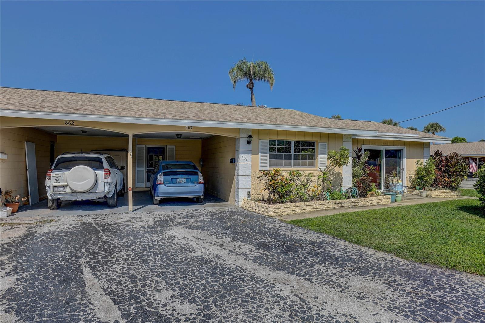 Fantastic Dunedin Location – Ideal for Seasonal or Year-Round Living! Welcome to Heather Hill, a vibrant 55+ condo community with a MAINTENANCE FREE LIFESTYLE. This is a NON-FLOOD ZONE and Non-Evacuation Zone and this unit had no damage from last years storms. This 1 bedroom/ 1 bathroom Villa is AFFORDABLE & Priced to SELL. This unit has a long shared driveway and a carport right to your door so you won't get wet when it is raining. This adorable unit has an OPEN floor plan with a spacious Living Room. The Kitchen has been updated with GRANITE countertops and a custom ISLAND to match. There are wood laminate floors throughout for easy cleaning and maintenance. There is a large closet in the hallway that provides loads of storage. There is sun-filled Florida room that is a perfect space for sipping your morning coffee or reading a book. There is also a screened in porch overlooking peaceful green space. Just steps away and across the street, you will find the laundry facilities, the clubhouse with a kitchen & social hall, a screened porch, the HEATED POOL, paved sun deck, and shuffleboard. This PRIME LOCATION is just minutes from vibrant downtown Dunedin, with easy access to major roads, shopping, restaurants, and world-class Gulf beaches including Honeymoon Island. Just a few miles away is spring training for the Toronto Blue Jays and Philadelphia Phillies. The LOW MONTHLY FEE of $457.18 covers cable, internet, exterior maintenance, insurance, lawn care, trash, water/sewer, and even the roof—truly low-maintenance living! You only pay for your electric bill. This is one of the lowest condo fees in all of Pinellas county. Don't miss this rare opportunity to enjoy Florida living at its best – whether you're a full-time resident or a snowbird seeking a sunny winter escape.
