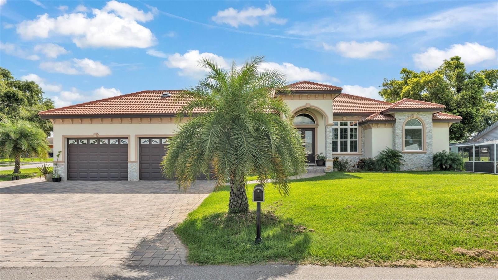 Stunning Newly Built (2023) Modern hacienda with luxurious finishes and a beautiful view of Lake Jessie—and best of all, no HOA! This spacious 4-bedroom, 4-bathroom home offers an expansive open floorplan, soaring high ceilings, and porcelain tile throughout, blending comfort and elegance in every room. The living area is anchored by a dramatic porcelain tile fireplace, creating a warm and stylish focal point.
The chef’s kitchen is a true showpiece, featuring sleek quartz countertops, stainless steel appliances, and modern cabinetry with clean lines and ample storage—perfect for both everyday living and entertaining. Just off the main living space, you'll find a spacious indoor laundry room with added functionality and convenience.
Additional highlights include a 4-car garage, ideal for multiple vehicles or a home workshop, a durable tile roof, and a whole-home water filtration system for high-quality water throughout. For added peace of mind, the home is also pre-wired for a security camera system, offering smart-home readiness and convenience.
Enjoy outdoor living year-round with a fully enclosed porch and a generous paver patio, perfect for relaxing or entertaining family. Located across the street from a public boat ramp, this home offers easy access to boating and recreation without the maintenance of direct lakefront living.
An exceptional opportunity to own a stylish, move-in-ready home with thoughtful upgrades, modern design, and a prime location near the water—with no community restrictions. Schedule your private showing today!