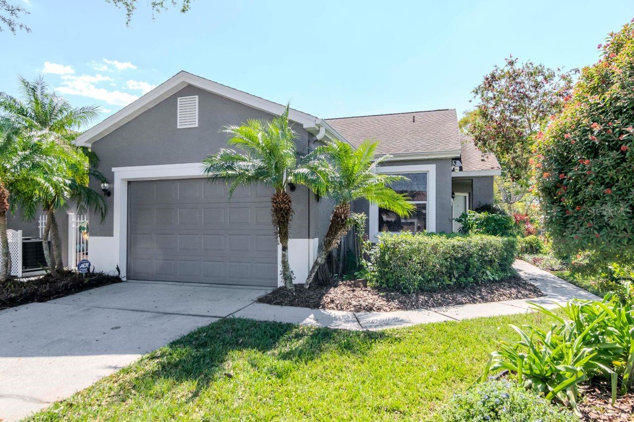 Must-see opportunity! This charming, move-in ready villa in the highly sought-after, gated 55+ golf community of The Groves has just been refreshed and now includes a $5,000 closing credit—perfect for kitchen appliances, additional upgrades, or closing costs. The seller has recently completed several key updates to make this home shine, including fresh interior paint, brand-new carpet in both bedrooms, modern light fixtures, and a granite countertop in the primary bathroom, along with other thoughtful touches throughout. These improvements ensure the home is in excellent condition and ready for its next owner. Positioned on a premium corner lot and backing onto a peaceful conservation area, this villa offers rare privacy and natural views. One of its standout features is the extended, oversized lanai, a unique highlight in this price range. It’s the ideal space to relax, entertain, and enjoy the tranquil preserve setting. Inside, the open-concept layout flows seamlessly from the front courtyard into a spacious living and dining area, and out to the oversized lanai. The kitchen features wood cabinetry and a breakfast bar, and is fully functional. The split-bedroom floor plan offers privacy for guests and owners alike. The primary suite features conservation views, a walk-in closet, and a refreshed en-suite with a walk-in shower and updated granite vanity top. The guest bedroom and adjacent full bath are perfect for visitors or hobby space. Additional highlights include Pergo flooring in the main living areas, a newer roof (2019), new water heater (Dec 2024), fresh exterior paint (2022), and a golf cart included with the sale, making it even easier to enjoy everything The Groves has to offer. This vibrant 55+ community features a championship golf course, pickleball, tennis, bocce, fitness classes, social events, and a full-service clubhouse restaurant. The HOA fee includes lawn care, Spectrum TV & Internet, roof replacements, exterior painting, and access to all amenities—providing a truly low-maintenance lifestyle. Located just minutes from shopping, restaurants, and medical centers—and only 30 minutes to Tampa International Airport and 40 minutes to the Gulf beaches—this home offers comfort, convenience, and community.
Don’t miss your chance to own one of the best values in The Groves—schedule your private showing today!