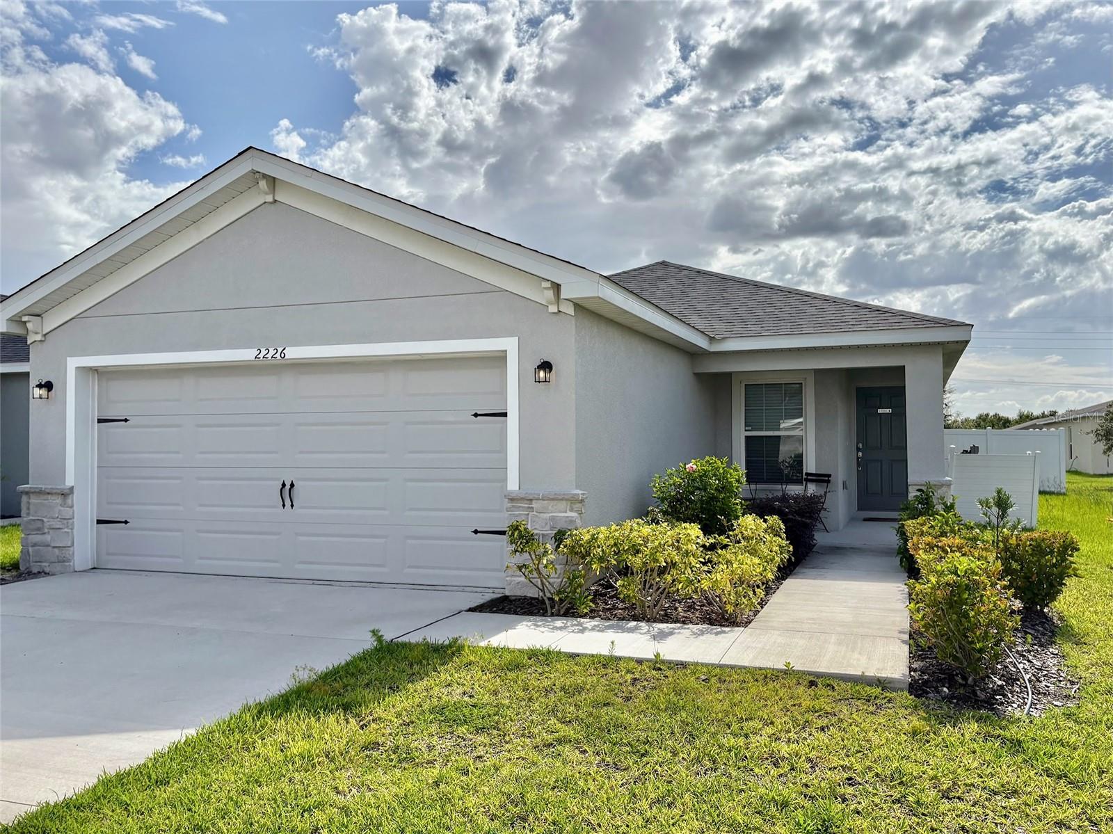 Welcome to 2226 Majestic Span Avenue, Eagle Lake, FL – now available for rent fully furnished and move-in ready! This beautifully maintained 3-bedroom, 2-bathroom single-story home offers 1,543 square feet of open-concept living space designed for comfort and style. The spacious kitchen features 36” shaker-style birch cabinets with crown molding, a large island with seating, walk-in pantry, and Samsung stainless steel appliances. Luxury vinyl plank flooring runs through the main living areas, laundry room, and bathrooms, while the bedrooms are carpeted with soft, stain-resistant flooring. The private owner’s suite includes a generous walk-in closet and a spa-like en-suite bathroom with dual vanities, a fully tiled walk-in shower, and private water closet. Enjoy outdoor living on the covered lanai, plus added features like a 2-car garage, custom blinds, and energy-efficient windows. Conveniently located near schools, shopping, and major roadways, this furnished rental is ideal for tenants seeking a stylish and low-maintenance lifestyle in Central Florida. Schedule your showing today!