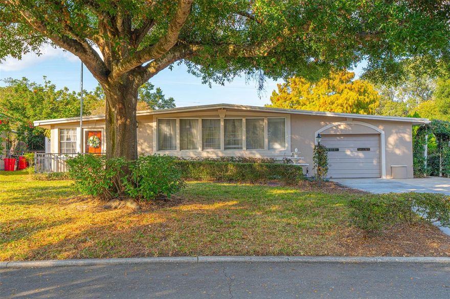 Welcome to this lovingly maintained 3-bed, 2-bath single-family home located in the highly sought-after Pershing Terrace neighborhood of Orlando, FL. Offering 1,721 sq ft of cozy, well-kept living space, this property has been owned by the same family since it was built in 1959—showcasing decades of care and pride. Sitting on a generous lot, the home features a large fully enclosed attached porch that seamlessly connects to the kitchen through an interior access door, while also providing convenient entry from the garage. One of the standout features of this property is the detached fully enclosed building with its own air-conditioned studio space of 520sq ft. Including its own rear driveway to the street located behind the property (Simonton Avenue) and gates already built into the vinyl fencing —an incredible opportunity for those seeking extra space. This versatile structure also has a 160sf workshop adjacent to the Backyard Studio or could be converted into an in-law suite / rental unit (subject to applicable city/county regulations). You will not have to worry about the Florida heat inside the workshop or the studio space as both areas are equipped with window units for cool air. Located in one of Orlando’s most desirable ZIP codes, this home blends charm, functionality, and future potential—perfect for homeowners or investors looking to make a smart move in a prime area.