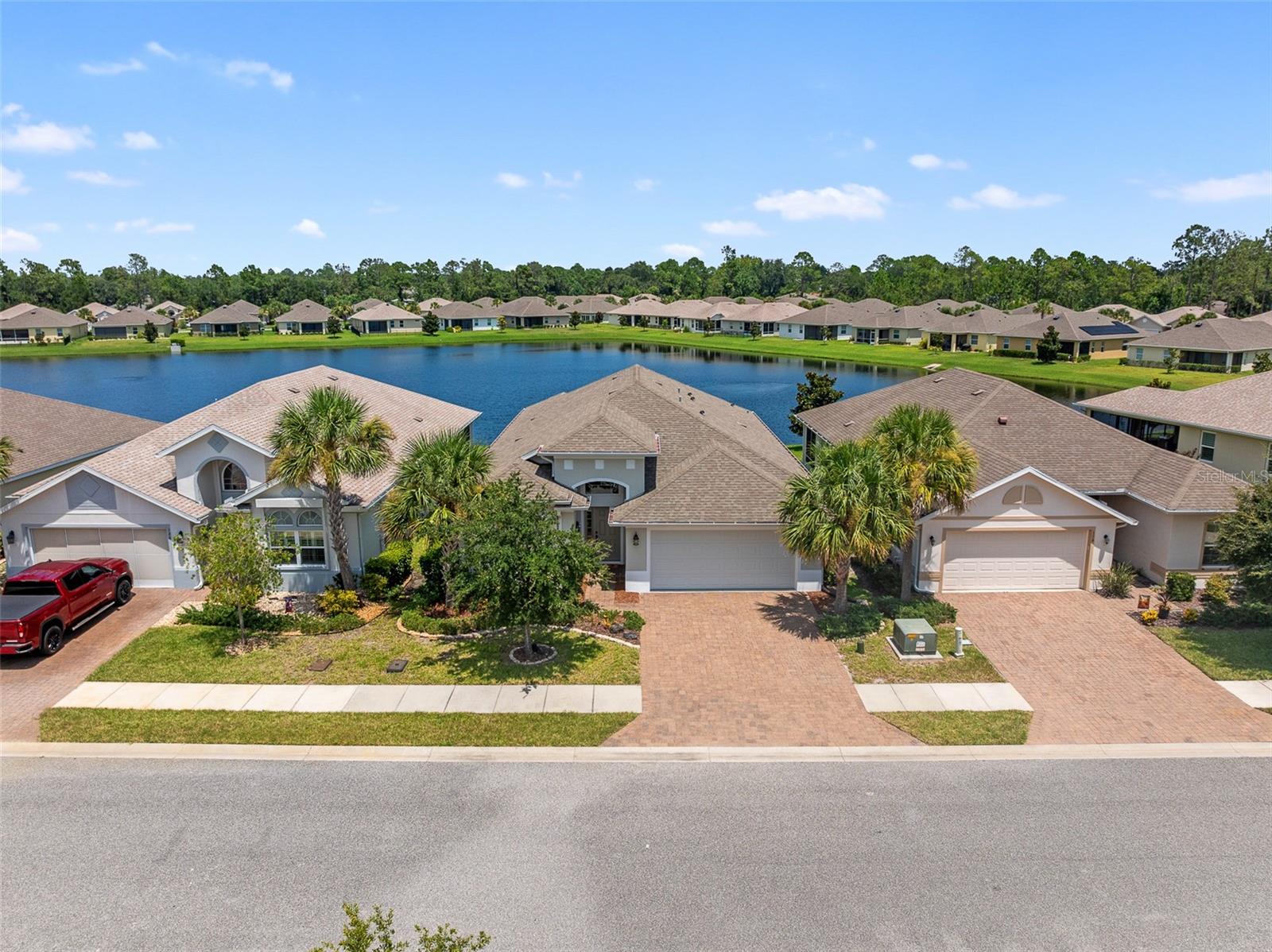Welcome to this move-in ready Seagate home with peaceful water views, located in a gated 55+ community offering resort-style amenities including a heated pool, pavilion with grill, putting green, shuffleboard, and more. As you arrive, you’ll notice the paver driveway, walkway, and freshly painted exterior. Step inside to a bright, open layout featuring hurricane-rated tilt-in windows, 2” blinds, marble window sills, and ceiling fans throughout. The kitchen is equipped with a gas stove, 42” wood cabinets, pull-out shelves, and pot/pan drawers, and opens into a spacious living and dining area. Just off the primary bedroom is a large flex room ideal for a home office, exercise area, or quiet sitting room. The primary suite also features a custom walk-in closet and an en-suite bath, while two guest rooms and a full guest bath offer plenty of space for visitors. Enjoy the outdoors in the extended screened lanai, enlarged by 5 ft to take full advantage of the breezes and tranquil views. The 2-car garage is extended by 2 ft and includes attic access for extra storage. A whole-house Generac generator with in-ground, owned propane tank provides peace of mind. Additional features include large closets, in-ground sprinkler system, and a low HOA of just $230/month covering internet, cable, and full yard maintenance. This home blends function, comfort, and Florida lifestyle—schedule your showing today!