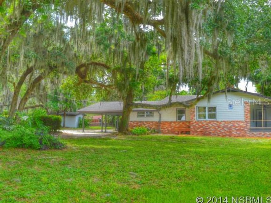 3 ACRES NSB -  Quiet and cute COUNTRY HOME on scenic Mooneyham Dr..  This country oasis has, a small storage shed with access to the well,  large drive-thru barn with workshop area and stalls on the north side, a detached in-law suite steps behind the privacy of a natural bamboo barrier.  The main house features a 3 bedroom 3 bath split floor plan.  2 of the bedrooms have their own private full bath and walk-in closet! The floors are reminiscent of old Florida w/ extinct hard pine that has been restored and brought back to life.  Hardwood kitchen with new 2014 stainless steel appliances, 3cm solid Santa Cecilia granite countertops, and a pop-out herb box kitchen window for all your basil and parsley needs.  Master bath has high ceilings and a spacious tiled walk-in shower.   New 2014 fixtures throughout!! New 2014 roofs an architectural driftwood color series on both the main house as well as the Detached In-law Suite complete with 1 bedroom, living room, kitchen, and private back porch. Quiet setting in the country yet near all New Smyrna Beach has to offer.