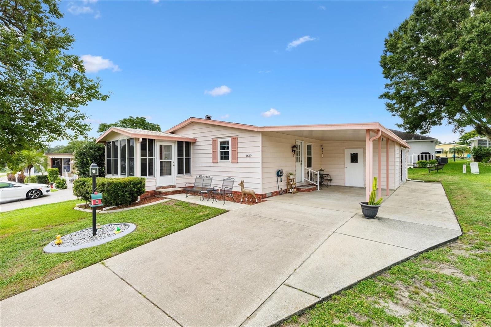 NO BOND, NO CDD! Updated 2/2 home in the Village of Orange Blossom Gardens. ROOF 2023, HVAC 2017 and newer Hot Water Heater. Step inside to find new luxury vinyl plank flooring, fresh interior paint, and new remote controlled ceiling fans with light kits.
The front-facing enclosed lanai offers a bright and inviting spot to relax year-round. Inside, the open living area includes a built-in desk in the hall—ideal for work or hobbies. The kitchen is outfitted with brand new appliances, plenty of storage and an appliance garage, keeping the counter tops clean and neat. The spacious primary suite features a walk-in closet and an ensuite bath, makeup desk, and step-in shower. The guest bedroom has a walk-in closet. Just across the hall is a guest bath with a tub/shower combo and a skylight that adds natural light. This home also includes a golf cart garage with a new electronic door, and an adjacent utility/laundry room. Both areas having extra storage for all your yard equipment, and a peg board system for tools, crafts and other supplies.
Walking distance to the Orange Blossom Hills Golf and Country Club and Pool and Hill Top Adult Pool. Less than a mile to the Hill Top Golf Course 1st Tee. Less than 2 miles to Spanish Springs Town Square for entertainment, dining and shopping. This location can’t be beat. Be sure to watch our video of this outstanding home. Call today to schedule your private showing and start living The Villages dream. This home is a must see. golf Cart being sold separately for $5,000.