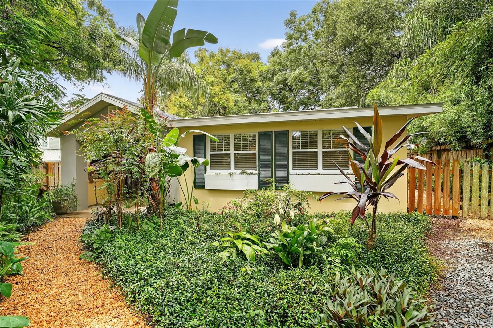 Charming Cottage in Mount Dora! Welcome to this delightful 1-bedroom, 1-bathroom bungalow nestled in the heart of Mount Dora on a dead end street hidden behind the coveted Mossy Oak Cottages. Overflowing with warmth and character, this home offers the perfect blend of convenience, comfort, and small-town charm. The lush landscaping sets the stage as you approach the inviting front screened porch. Inside, French doors open to a light-filled living space with tile flooring, where thoughtful details and a functional layout make every square foot of this adorable cottage count. The kitchen is well-proportioned and features a center island with gas cooktop and bar seating. Just off the kitchen, the laundry room includes a washer, dryer, and storage cabinets for added functionality. The bedroom provides a quiet retreat, while the full bath features a walk-in shower. French doors from both the kitchen and bedroom open to the quaint, landscaped and fenced backyard with backyard deck, the perfect spot for morning coffee or evening relaxation. FEATURES INCLUDE: BRAND NEW ROOF AUGUST 2025, NEW EXTERIOR PAINT SEPTEMBER 2025, NEW SEPTIC 2022, UNDERGROUND UTILITIES, QUANTUM FIBER, OFF STREET PARKING, ON DEMAND HOT WATER HEATER AND HVAC 2012!! Located within walking distance to shops, cafés, and Mount Dora’s historic downtown, this cottage offers both charm and convenience while maintaining a peaceful, private setting. Whether you’re searching for your first home, a weekend getaway, or a downsized lifestyle, this storybook cottage delivers with grace and possibility. Some furnishings are negotiable.