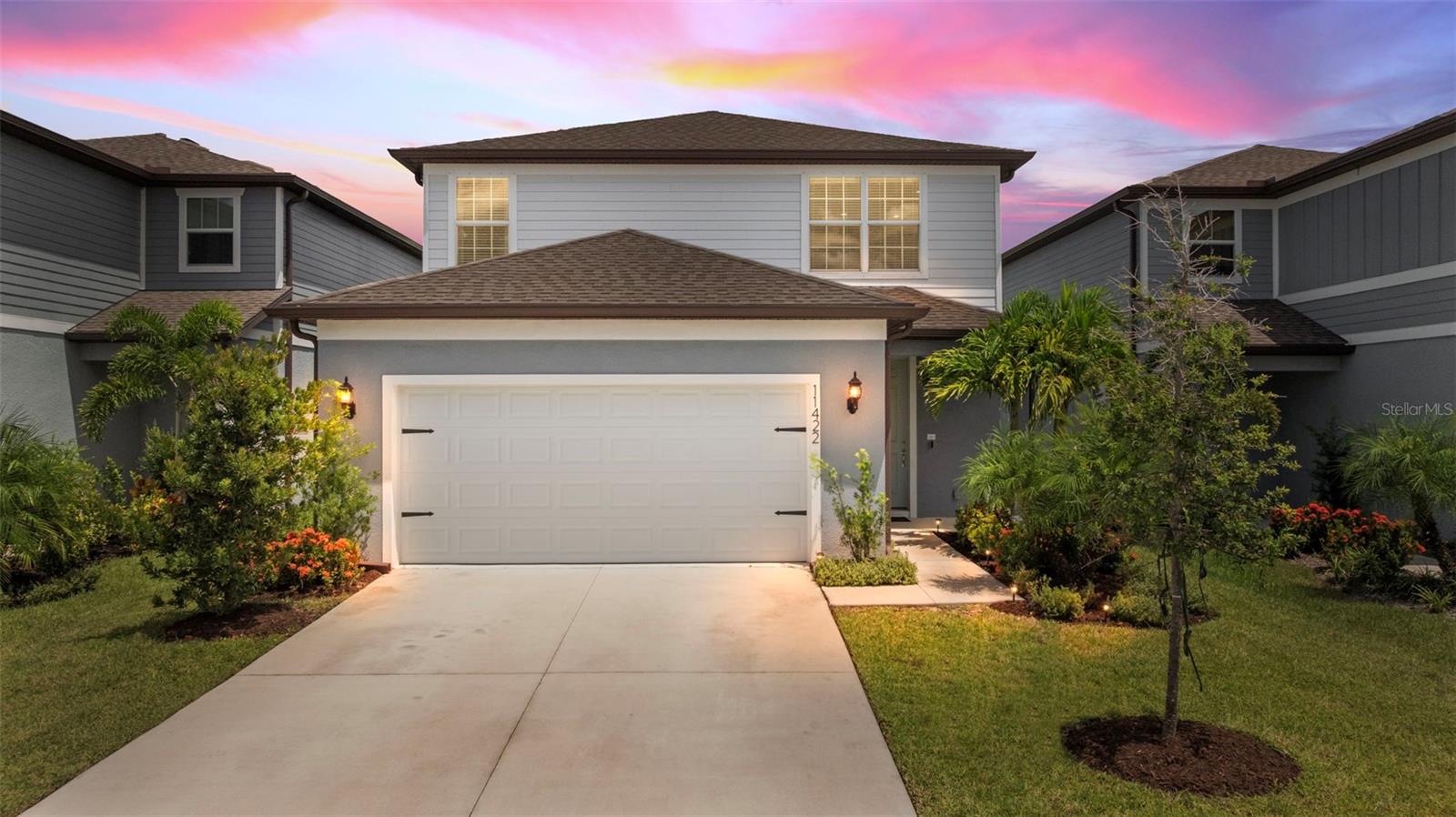 Welcome to YOUR next home in the Brightwood neighborhood at North River Ranch! Built in 2023 by Pulte, this 4-bedroom, 3-bath, 2,202-sq-ft home pairs a light, airy aesthetic with a smart, family-friendly layout. Step inside to wide-plank luxury vinyl floors, crisp white walls, and an open concept living room that naturally gathers everyone together. The living room’s custom shiplap accent wall and built-in media center set the stage for cozy movie nights and effortless style. The kitchen anchors the space with shaker cabinetry, quartz counters, stainless appliances, a pantry, and a statement island with pendant lighting. Sliding glass doors extend the living area to a generous screened lanai, with double doors overlooking the open green space—ideal for morning coffee, weekend grilling, and easy indoor-outdoor flow.
A convenient first-floor bedroom and full bath are perfect for guests or a quiet home office. Upstairs, a large loft flexes as a play space, media lounge, or homework zone. The private primary suite offers calm, preserve-style views, a large walk-in closet, and a spa-inspired bath with double vanity, quartz counters, and a tiled shower with built-in bench. Two additional bedrooms, the second full bath, and an upstairs laundry keep daily life simple and organized. Thoughtful touches include ceiling fans, custom trim details, window treatments, hurricane shutters, irrigation, and rain gutters.
Living here means access to the resort-style amenities that make North River Ranch so sought-after. The Brightwood Pavilion features a sparkling pool, fitness center, game room, event lawn, playground, fire pit, and Avid FitPod stations, while miles of interconnected trails, bike share, and Dash’s Bark Park bring the active, outdoor lifestyle right to your doorstep. You'll also have access to North River Ranch’s newest amenity campus, Camp Creek, which offers over 12 acres of fun with its Headwaters Swim Center, featuring a heated resort-style pool, zero-entry area, and double-loop water slides. The centerpiece of Camp Creek is a 4,859-square-foot vintage-inspired clubhouse, thoughtfully designed for both social moments and productivity. Inside, you’ll discover a cozy lounge area called “The Nest,” a Canteen-style grab-and-go café, and a fully equipped business center with individual workspaces—perfect for remote work, quiet study, or catching up on emails without leaving home. Whether you're gathering with neighbors or wrapping up your to-do list, it strikes the ideal work-life balance.You’ll also enjoy access to the third community pool at Riverfield, giving you even more options to cool off, relax, and connect with neighbors. Market Walk—with Publix, liquor store, and convenient services—is just up the road, and you’re moments from on-site schools, including both Barbara A. Harvey K-8 campuses and Parrish Community High. Commuting is a breeze with quick access to I-75, US-301 and US-41; downtown St Pete, Tampa and the gulf beaches.
If you’ve been looking for a nearly new, move-in-ready home with the space you want and the amenities you’ll actually use, this is the one. Welcome home!