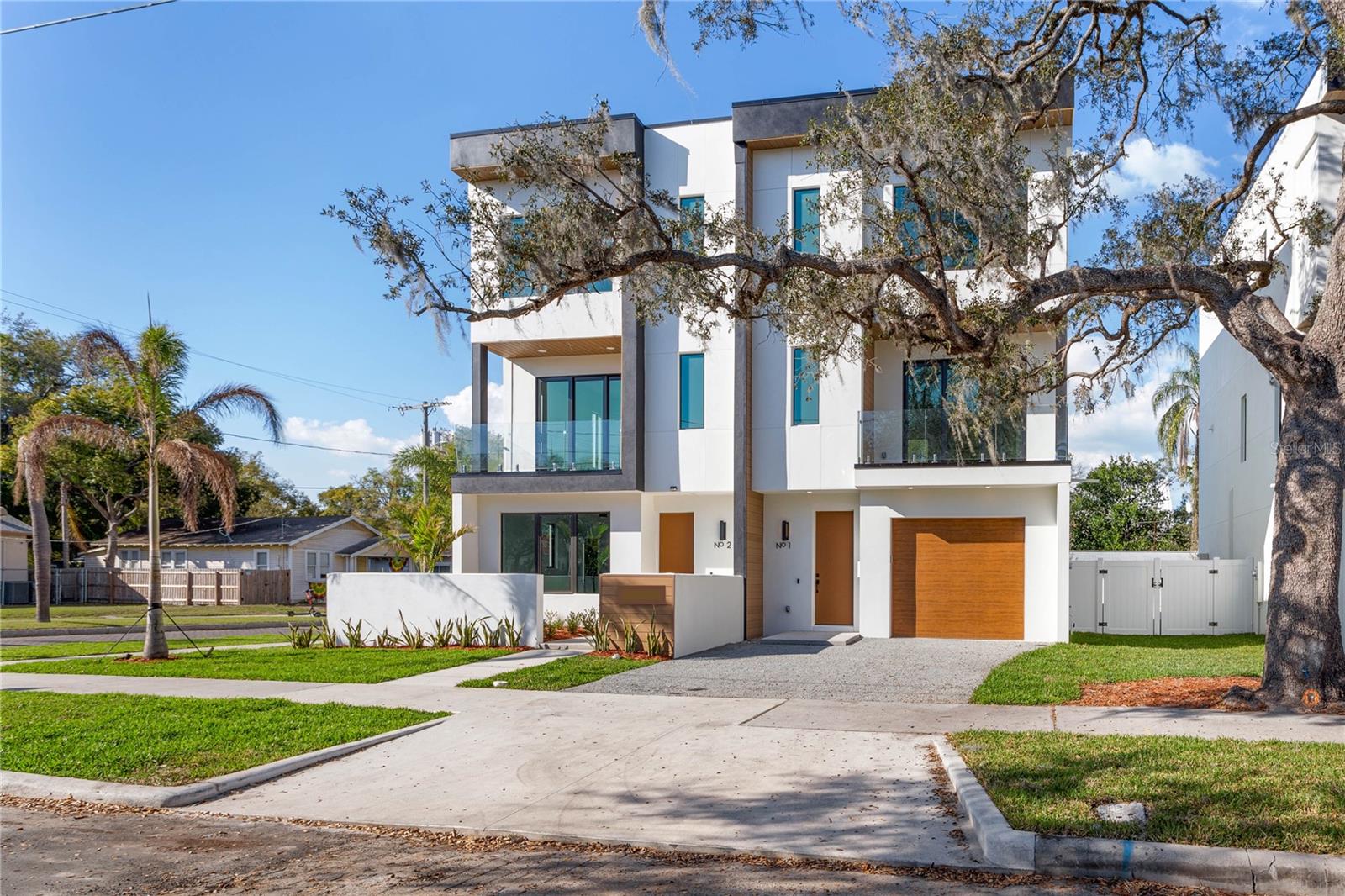An unmatched opportunity — the most desirable unit at Gladys Residences with no HOA and no rental restrictions. This corner unit is unrivaled, featuring the largest private fenced backyard, a welcoming front courtyard, and the only attached two-car garage in the development. Spanning three levels, this townhome is defined by elevated design and functionality. Inside, the commitment to detail is evident. Every inch of this home showcases an unprecedented standard of quality- from all-block construction to impact-rated windows and doors. The second level showcases an open-concept living, dining, and kitchen area designed for both everyday living and entertaining. At its heart is a chef’s kitchen, complete with a professional-grade gas range, premium stainless-steel appliances, European-style soft-close cabinetry, and a waterfall island that provides abundant prep space and seating. An expansive glass staircase makes a bold architectural statement, while oversized impact windows bathe the interiors in natural light. The residence also offers a private balcony, extending your living space outdoors. Every bedroom boasts its own en-suite bathroom, complemented by electric blackout shades for privacy and comfort at the touch of a button. Currently fully staged, 117 Gladys may also be purchased turnkey as a luxury rental investment, providing immediate appeal for homeowners or investors. Positioned in the heart of Tampa Heights, this home offers effortless access to some of the city’s most sought-after destinations: Armature Works, the Riverwalk, Downtown Tampa, Michelin-starred dining, and I-275. The neighborhood continues to thrive with the upcoming $600 million YMCA and Gasworx Developments, reinforcing Tampa Heights as one of the city’s most exciting addresses. 117 Gladys delivers a one-of-a-kind blend of modern aesthetics, quality, and prime location. Don’t miss your opportunity to secure the finest home in Gladys Residences. Schedule your private showing today.