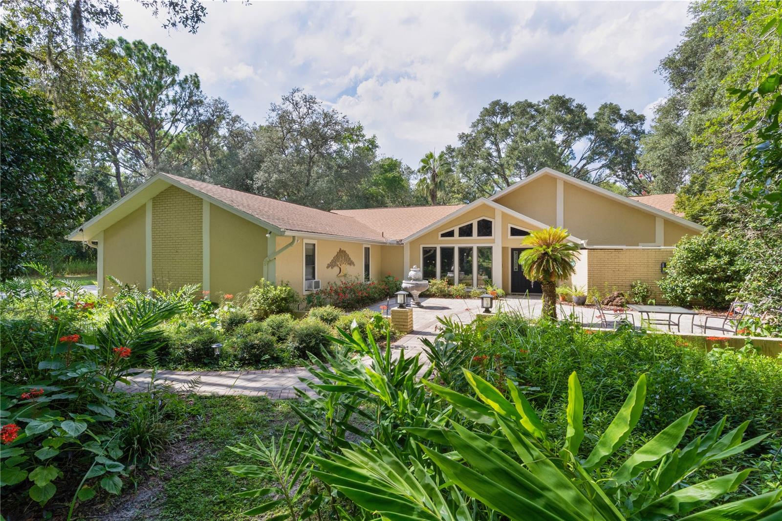 NATURE LOVERS PARADISE! This home has a lot to behold however please refrain from walking the property without requesting a showing. Located in the illustrious equestrian community of Pine Ridge Estates, this cozy 3 bed 2.5 bath HEATED POOL home, is nestled in a park-like setting on an oversized corner lot. A double door entrance, gorgeous custom paver patio with a water fountain feature and stained glass windows promote a warm welcome and will surely impress your guests. Stepping inside you are greeted with vaulted ceilings, Pergo flooring and tile throughout, freshly painted walls and large windows that flood the home with natural light, creating an inviting atmosphere. The well appointed kitchen features stainless steel appliances, granite countertops, a breakfast bar and even a ceiling fan to help keep you cool while cooking. The adjacent dinette area offers a spot to enjoy your morning coffee and the separate formal dining area offers a perfect setting for family meals or entertaining guests. The living room provides a cozy retreat for relaxation while overlooking your pool through hideaway sliding glass doors and offers 4 electrical plugs in the floor. The primary suite is a haven of tranquility, with a secluded spa-like ensuite bathroom and direct access to the outdoor heated pool oasis. Off the master bath you can walk out into your private atrium. NEW POOL HEATER 2025. Roof replaced 2016. Garage is fully functional for car storage however it has been finished with luxury vinyl plank flooring and ceiling fans to use as a den, game room or host the family parties! Step into the backyard to discover a tropical paradise within your oversized screen in lanai complete with a sparkling diagonal pool, surrounded by lush landscaping for ultimate privacy. This outdoor haven is an ideal space for dining, lounging in the sun, or entertaining friends under the stars. Conveniently, a third bathroom is located in the lanai providing easy access for your pool goers and storage space for all of the pool toys. Beyond the fruit trees, palms and large magnolias you will find an abundance of flowering trees and bushes just waiting for you to stroll through and enjoy. Multiple irrigation zones throughout the entire property ensure proper watering. Don’t forget to check out the laundry room. Here you will find a built in ironing board, cabinets and desk. The 2.5 car garage is insulated, has vinyl plank flooring, ceiling fans, washing machine, sink and attic storage. Next to the home you will find 2 fenced areas and a storage shed. WASHER and DRYER INCLUDED. FURNITURE NEGOTIABLE. Crystal chandeliers at entrance do not convey and will be replaced prior to sale. Located in the sought-after Pine Ridge Estates, this home offers not just a residence but a lifestyle, combining elegance with the charm of the surrounding community. With its impeccable design and premium amenities, this 3-bed, 2.5-bath pool home stands as a testament to luxurious living in a prime location. Located within 30 minutes from Rainbow Springs and Dunnellon, 45 minutes from Downtown Ocala and WEC and 1 hour 15 minutes from Tampa Airport.