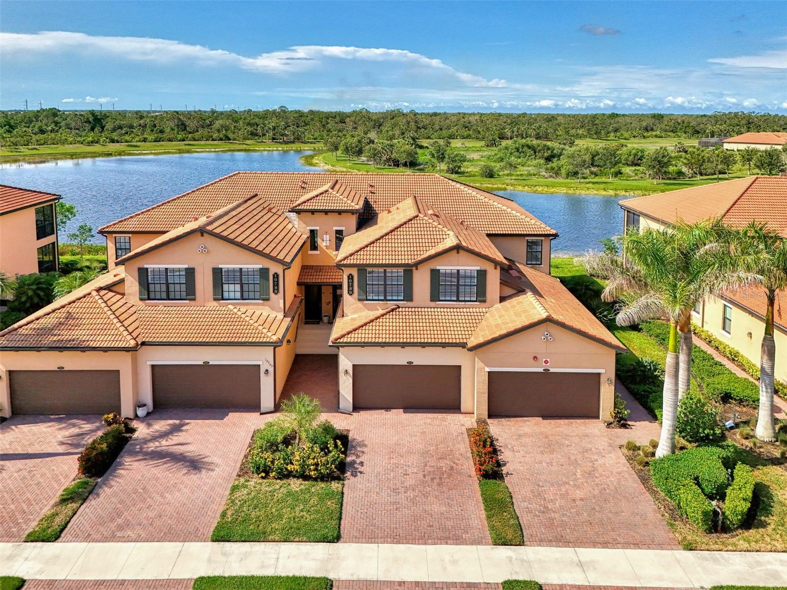 Now is your opportunity to live in this beautiful TOP FLOOR END UNIT condo, located in the highly sought after guard gated community of Sarasota National. Enjoy SOUTH FACING water, preserve, and golf course views stretching in all directions that will bring you hours of peace and enjoyment right from the comfort of your oversized screened lanai with custom sun shade. Boasting a grand 2-story foyer entrance, this condo is flooded with light and features an open concept floor plan featuring 3 bedrooms and 2 bathrooms, as well as a 2 car garage with a 3rd tandem. From the moment you walk through the decorative lead glass front door, you will notice upgrades such as tile on the diagonal and decorative crown moldings that run throughout all of the main living areas, as well as custom plantation shutters and custom drapery in the living room. The kitchen is a chef's dream that features white shaker style cabinets, beautiful quartz countertops, and an upgraded stainless steel appliance package with new Bosch dishwasher, LG refrigerator, and upgraded Delta faucet. Enjoy stunning views while you prepare a fantastic meal that is easily served buffet style on the oversized island. The pantry has custom built-ins by Closet-Tec and the oversized dining area showcases a beautiful chandelier. The entire space is filled with light thanks to large windows throughout and oversized sliders that all feature the highest rated HURRICANE IMPACT GLASS! The primary suite is huge on space with room to create a home office or extra sitting area. Large sliders lead out to the lanai, and a huge window will allow you to enjoy the stunning views from every angle. 2 walk-in closets give you ample space and you will enjoy more custom built-ins by Closet-Tec. The en suite bathroom showcases dual vanities with tons of storage, an oversized walk-in shower with seamless glass enclosure, and a separate water closet. Across the condo you will find 2 additional bedrooms that are generous in size, and a large full bathroom that features a tub/shower combo. With a pocket door at the end of the hall, it is easy to create privacy for guests from the main living areas of the home. There is an in-unit laundry room with upgraded stackable washer and dryer, freeing up space for extra storage. This building is completely maintenance free and includes all landscaping maintenance, pest control, cable tv, water, sewer, and trash pick up. Your monthly HOA fee also includes 2 GOLF MEMBERSHIPS that require no extra buy-in fee! This condo is perfect to use as a full time residence, a part-time seasonal home, or even a great investment... one that will generate substantial rental income! Live like you are on a 5-star vacation with a 30,000sf clubhouse with resort style pool, hot tub, outdoor tiki bar serving food and drinks daily, a coffee house, fine dining restaurant, 7,000sf fitness center with top-of-the-line equipment and classes, day spa, card room, bocce ball, pickle ball, tennis, dog park, playground, event lawn, and 18-hole championship golf course. Sarasota National is a guard gated 2400-acre International Audubon Bird Sanctuary that offers some of the most beautiful water and preserve views in all of Venice. This home is just minutes to the new Atlanta Brave's spring training camp at the CoolToday Park Stadium, as well as the town center of Wellen Park. Explore 3 local beaches and historic downtown Venice, all less than 15 minutes from your front door!