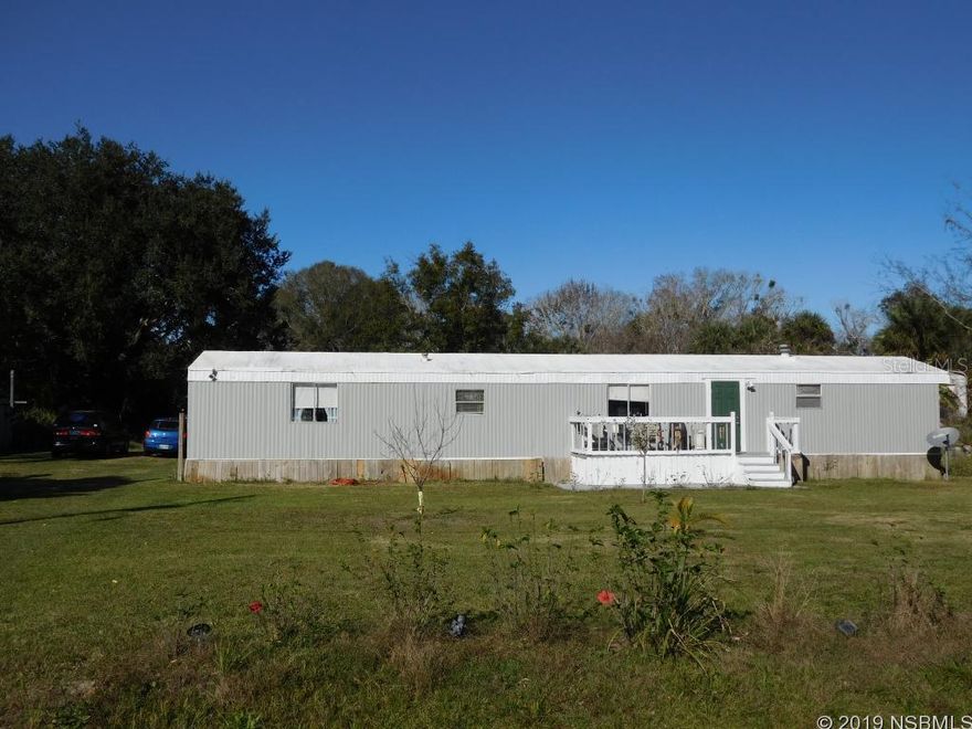 Affordable place in the country, yet close to town for convenience. This home has 3 bedrooms, 2 full baths and a comfortable split plan layout. Lots of recent repairs and updates starting with the sub floors - new plywood throughout (no particle board), new carpet, vinyl plank and wood. New commodes in both bathrooms and new master vanity. Freshly painted inside & out. Beautiful large lot with several shade trees, fruit & citrus trees and flowering shrubs, riding mower included.