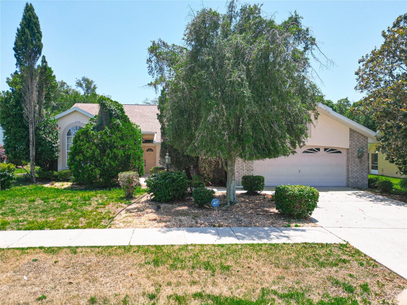 WELCOME TO 6147 N WHISPERING OAK LOOP, A SPACIOUS 2257 SQ FOOT THREE BEDROOM TWO FULL BATH HOME WITH NO REAR NEIGHBORS. THIS HOME HAS A SPLIT BEDROOM PLAN WITH OVERSIZED BEDROOM SIZES ALL WITH WALK IN CLOSETS! SO MANY FEATURES INCLUDING VOLUME CEILINGS, BUILT-IN SHELVING AND A FIREPLACE IN THE 15X15 GREAT ROOM, BREAKFAST NOOK JUST OFF THE KITCHEN WITH A VIEW TO THE LANAI AND BEAUTIFULLY LANDSCAPED, PRIVATE BACKYARD. BUILT IN DESK WITH LARGE CLOSET SIZED PANTRY IN KITCHEN, A PASS THROUGH TO THE GREAT ROOM FOR SERVING GUESTS. HUGE 23X12 LANAI WITH A MINI SPLIT FOR SUMMER COMFORT. LANAI ALSO FEATURES BUILT IN CABINETRY AND SINK. THERE'S PLENTY OF ROOM FOR A TABLE, COUCH AND OTHER FURNITURE FOR INSIDE/OUTSIDE LIVING SPACE WITH ACCESS FROM PRIMARY BEDROOM, LIVING ROOM AND BREAKFAST NOOK. INSIDE LAUNDRY, CLOSETS IN GARAGE, DOUBLE DOOR ENTRY, LIGHTNING RODS, GUTTERS AND DOWNSPOUTS, ETC. THE LIST GOES ON. CALL FOR YOUR PRIVATE TOUR TODAY.