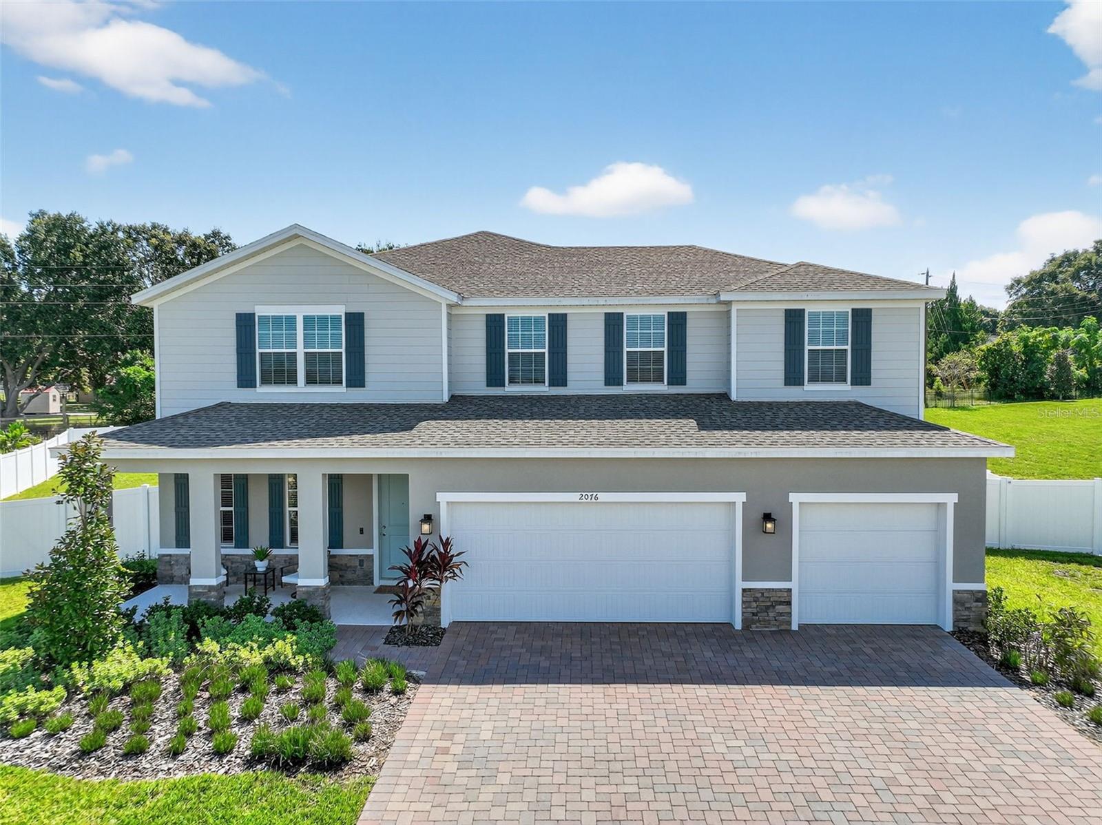 Welcome to your dream home in the highly desirable community of Bella Terra! This nearly new (less than a year old) 5-bedroom, 4-bathroom home sits on a generous 0.4-acre lot and offers the perfect blend of space, style, and functionality. From the moment you arrive, you'll be charmed by the inviting front porch—perfect for morning coffee or evening sunsets. Inside, enjoy thoughtfully upgraded features throughout, including modern fixtures, a beautiful shiplap electric fireplace, and a dedicated home office ideal for remote work or study. The open-concept kitchen, dining and living area flows seamlessly to the large extended lanai, providing the ultimate indoor-outdoor Florida lifestyle. Upstairs you will find a large loft/bonus space along with four of the five bedrooms and the laundry room. Whether you're entertaining or enjoying quiet evenings at home, this space is made to impress.Located in a prime spot, you'll enjoy peaceful surroundings while being just minutes from shopping, dining, top-rated schools, and all that Clermont has to offer.