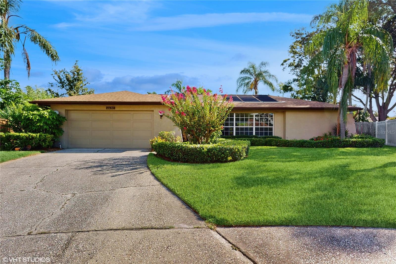 Loved for Decades, Ready for New Memories! Beautifully maintained, this pool home offers 4 BR, 2BA, and a 2-car garage with no HOA—the ideal blend of comfort, privacy, and convenience. Located in a tranquil cul-de-sac on one of the highest points in Pinellas County, the flood-safe setting provides peace of mind during storm seasons. Recent updates include a roof (2024), a pool screen (2024), a resurfaced pool (2023), and newer water heater. Additional features include a solar panel for pool heating, generator, hurricane shutters and water softener. The split-bedroom floor plan allows for privacy in the primary suite, while the main living areas are thoughtfully designed for both daily living and entertaining. As you enter the home, the living room flows seamlessly into the dining area on one side with sliding door to the pool area. On the other, a breakfast room with built-in cabinetry leads into a TV/media room. Both spaces connect at the heart of the home—the kitchen—featuring vaulted ceilings with skylights that fill the space with natural light. The spacious laundry room offers extra cabinetry for storage, along with a freezer and wine refrigerator. The outdoor space is a true highlight, featuring a beautiful pool and a spacious lanai—perfect for entertaining or relaxing in your own private oasis. Surrounded by lush tropical landscaping, guava and lemon trees, and a fully fenced yard, the backyard offers beauty and function, complete with an irrigation system with new pump and relay, plus a storage shed for garden tools. Conveniently located with quick access to US-19 and McMullen Booth Road, the home is just minutes from Countryside Mall, Whole Foods, Trader Joe’s, Publix, ALDI, multiple gyms, golf courses, and the Pinellas Trail. Downtown Safety Harbor and Downtown Dunedin are also close by, while Honeymoon Island and Clearwater Beach offer nearby coastal escapes. You're under 20 minutes to St. Pete–Clearwater International Airport and about 25 minutes to Tampa International Airport. With spacious layout, unbeatable location and beautiful landscaping this home is truly one of a kind. Schedule your showing today and experience the best of Clearwater living!