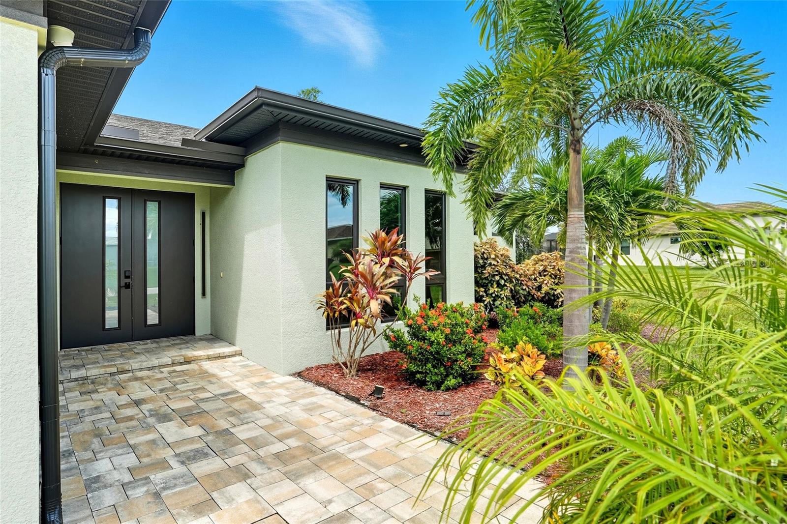 Sunsets, Space & Style — Sold TURNKEY and NOT in a Flood Zone! This western-exposure waterfront pool home in SW Cape Coral has it all: over 2,200 sq. ft. of living space, a sparkling pool with canal views, and a layout designed for both comfort and entertaining. Step through double front doors into a bright open floor plan with a stunning waterfall kitchen island, oversized cabinetry, and upgraded stainless steel appliances. Triple pocket sliders connect the indoors to the expansive covered lanai with a full outdoor kitchen—perfect for evening gatherings or quiet nights by the pool. Inside, you’ll find 3 spacious bedrooms, a versatile den/flex room, 2 full bathrooms, and a formal dining area. The flex room works beautifully as an office, playroom, or extra lounge space. Generous walk-in closets, upgraded lighting, a fully outfitted laundry room, and a seamless gutter system add thoughtful touches throughout.
