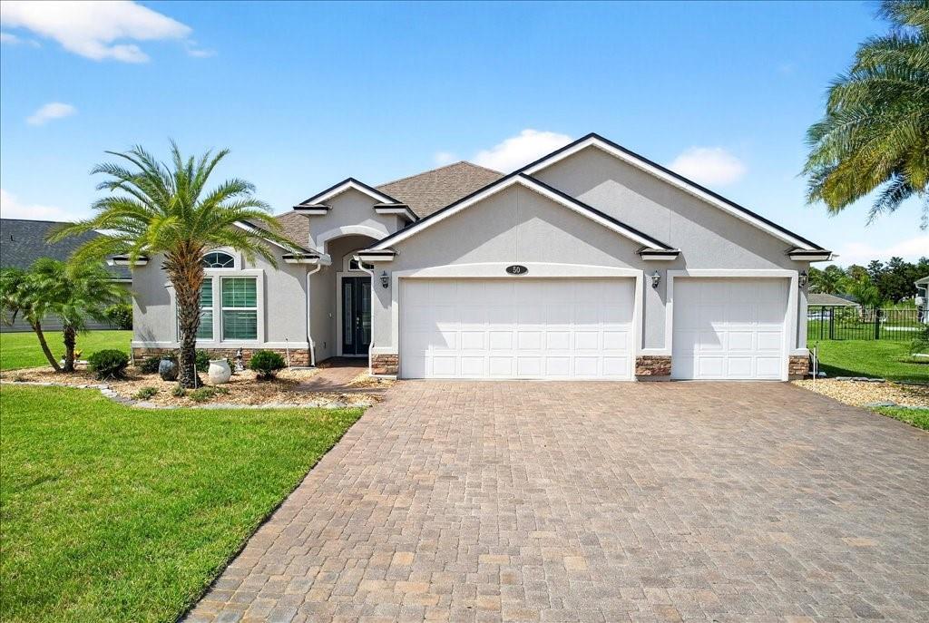 Located in the highly desirable Country Club Harbor community in on the saltwater canal, residents enjoy gated privacy, with access to miles of walking and biking paths and the European Village shopping area.
This thoughtfully designed home features 3 bedrooms, 3 full baths, and a versatile flex room—ideal for a home office or guest space. The open floor plan is enhanced by high ceilings and ceramic tile flooring throughout the main living areas, creating an airy, welcoming feel.
Step outside to your private retreat with a screened lanai, sparkling saltwater pool, and a boathouse complete with electric and lift—perfect for launching into the canal for a 5-minute ride to the Intracoastal Waterway.
Additional highlights include a corner lot, paver driveway and an expansive 3-car garage.
Blending comfort, convenience and the waterfront lifestyle, this home is a rare opportunity in one of Palm Coast’s most desirable neighborhoods.