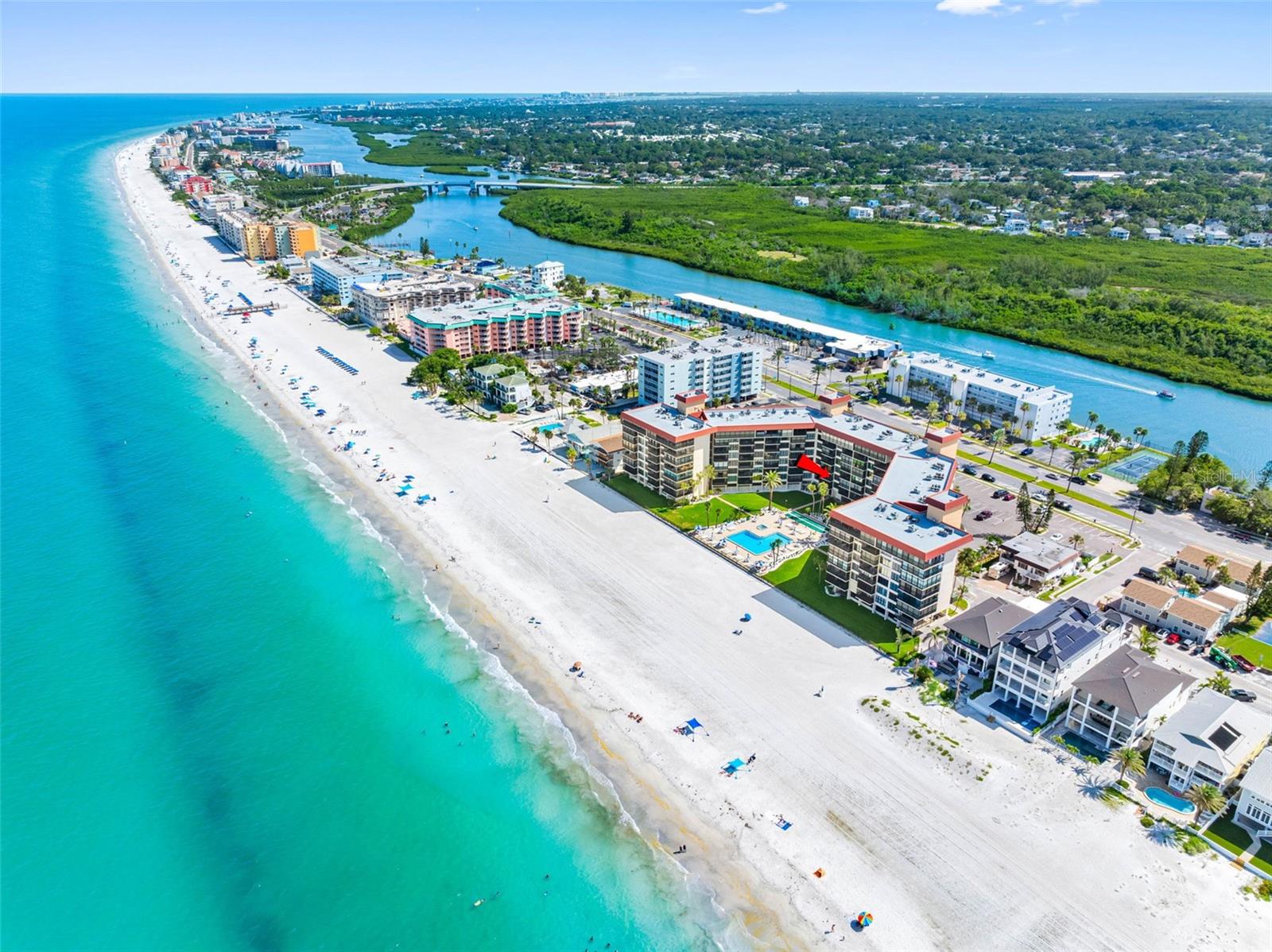 Direct Gulf-Front Condo in Redington Shores! Wake up to stunning beach views and end your day with spectacular sunsets from your spacious balcony and master bedroom in this beautifully updated 2-bedroom, 2-bath unit at the sought-after Shore Mariner 55+ Community. Enjoy modern upgrades not commonly found in other units—including a stackable inside washer and dryer, a built-in custom kitchen pantry with lots of storage, and clean ceilings with no exposed wiring for fans or lighting, and crown molding. The thoughtfully designed split bedroom layout offers en-suite bathrooms for both bedrooms, perfect for privacy and guest comfort. The kitchen boasts crisp white cabinetry, quartz countertops, stainless steel appliances, and a striking stone backsplash. Both bathrooms have been completely remodeled with plank ceramic tile flooring, new vanities, white tiled showers accented with listello tile, and frameless glass enclosures for a clean, modern aesthetic. Shore Mariner offers low monthly dues making this an exceptional value, and the Milestone Inspection has already been completed with no required repairs. Recent building updates include full exterior painting in 2024 and balcony concrete restoration-showing consistent, proactive maintenance. Resort-style amenities include a heated beachfront pool and spa, sauna, fitness room, clubhouse, outdoor grills, and more. This condo also includes a covered parking spot, with permitting already approved for installation. Don’t miss your chance to own a fully updated Gulf-front condo in one of the best-maintained and best-valued buildings on the beach!