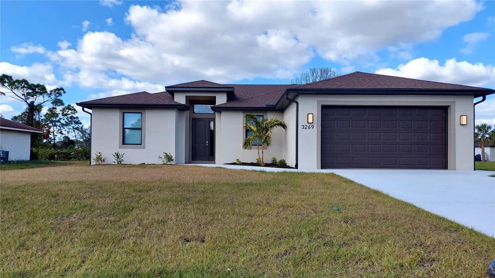 BRAND NEW HOME just completed with a den which can be utilized as a 4th bedroom, a home office, TV room etc. totaling 1,740 SF of livable space. The 2 car garage has a finished floor and upgraded lighting fixtures. The driveway is very long and can accommodate numerous vehicles.
This open floor plan has high ceilings, french doors opening to the large covered lanai, quartz countertops in kitchen and both baths, stainless steel kitchen appliances, LVT flooring throughout (no carpet) and window treatments on all windows. The master suite has a large walk-in closet, dual vanity sinks and walk-in full tiled shower. The guest bath has a full tiled shower/tub combination. The wood kitchen cabinets and large pantry provide ample storage space. Next to the kitchen is the laundry room which has washer and dryer hookups. Upscale remote control fans and lighting are provided in all living spaces. This home also has public city water thus there is no need for a water well. The backyard consists of a large covered
19'x 10' lanai