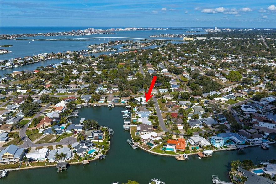 WATERFRONT LIVING IN PRESTIGIOUS HARBOR HILLS!!!  Welcome to this stunning 3-bedroom, 3-bath waterfront retreat with a 2-car garage, perfectly situated in the highly desired Harbor Hills neighborhood—known for its peaceful setting, pride of ownership, and true Florida waterfront lifestyle.  From the moment you arrive, you’ll be impressed by the circular driveway and professionally landscaped grounds, creating both curb appeal and convenience for guests. Step inside to a contemporary, open-concept design filled with natural light and beautiful water views from the living room, kitchen, and primary bedroom.  The open kitchen is ideal for entertaining, seamlessly connecting to the main living areas and offering stunning waterfront scenery while you cook or gather with family and friends. Tile flooring throughout the main living areas enhances the clean, modern feel, with carpeted bedrooms providing comfort and warmth.  Designed for both relaxation and entertaining, the outdoor living space features a spa—ready for year-round enjoyment with the addition of a heater—creating your own private oasis. Whether hosting sunset gatherings or enjoying quiet mornings, this home offers a serene and tranquil waterfront escape.  A true standout feature is the covered dock with boat lift, have a friend who wants to come by boat, no worries, there is an extra wet slip for them to dock at!  This is an increasingly rare find—allowing you to boat directly from your backyard to favorite waterfront restaurants, local attractions, and open water adventures.  Located just minutes from shopping, dining, and some of the area’s most beautiful beaches, Harbor Hills offers a unique combination of quiet residential charm and unbeatable convenience. This is Florida waterfront living at its finest—perfect as a full-time residence or luxury retreat as AIRBNB is allowed.  Full hurricane protection and no damage in prior hurricanes.  Homes like this, in this location, rarely become available.