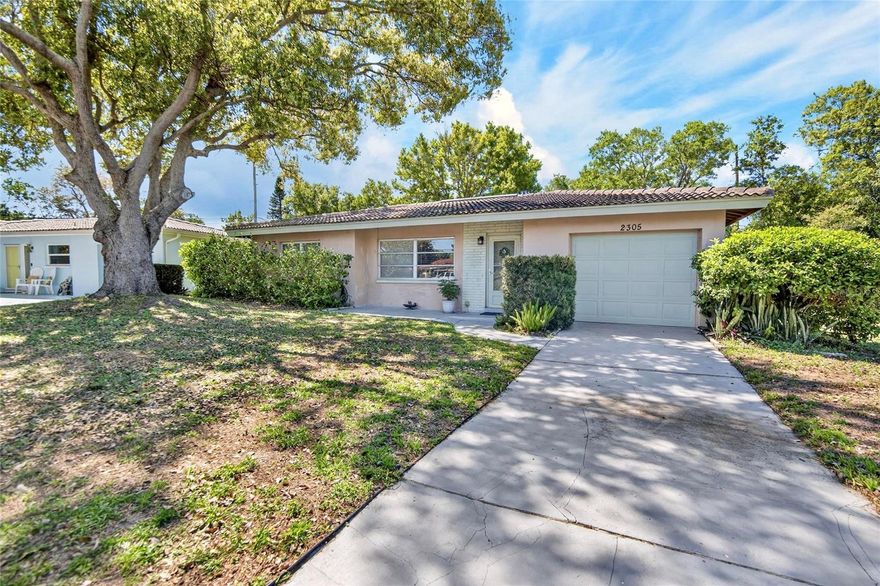 Welcome to the ever-popular Greenbriar community, where location, lifestyle, and opportunity come together in the best way. Situated at 2305 Indigo Dr., Clearwater, this charming 2-bedroom, 1-bathroom block construction single-family home with a 1-car garage is your chance to create something truly special.

With 857 heated square feet and 1,463 total square feet, this home is a blank canvas ready for your vision. No wallpaper, no carpet—just a clean slate waiting for your personal touch. Whether you're an investor, seasonal resident, or buyer ready to design your dream space, this is where the fun begins.

Step outside and you’ll quickly fall in love. The screened back porch is pure magic—peaceful, private, and the perfect place to unwind. The fenced backyard is filled with lush Florida landscaping where birds sing and the atmosphere feels wonderfully tranquil. Gardeners and outdoor lovers will appreciate the space and serenity.

Out front, nature adds a bit of charm and personality to daily life, as the neighborhood peacocks are known to casually stroll through the yard, creating one of those uniquely Florida moments that never gets old.

The home includes a newer washer and dryer, adding convenience from day one.

While this property is not required to be in the HOA, you have the option to join and enjoy access to Greenbriar’s heated community pool, fitness room, and active clubhouse with regular events—all at a low cost for those who want the added lifestyle perks.

And then there’s the location. Just about 8 miles from the world-famous Clearwater Beach, you’re never far from sugar-white sand and breathtaking Gulf sunsets. You’re also minutes to downtown Dunedin, Countryside Mall, top-rated hospitals, golf courses, restaurants, and local attractions. Catch spring training games nearby with both the Phillies and Blue Jays, or explore everything this vibrant area has to offer.

Located in a non-flood zone, this property offers peace of mind along with endless potential.

Whether you're looking for a full-time residence, winter getaway, or investment opportunity, this Greenbriar gem delivers block construction durability, an unbeatable Clearwater location, and the opportunity to make it completely your own.