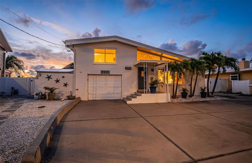 Welcome to 16137 4th Street East in Redington Beach – a rare opportunity to own a true waterfront retreat on a peaceful cul-de-sac just steps from the sand. Perfectly positioned on a wide canal with a 90-ft seawall and private dock, this 2BR/2BA home offers direct Intracoastal access for boating, paddleboarding, or simply soaking in the coastal vibe. It’s also right along the route of the beloved Redington Beaches Holiday Boat Parade, giving you front-row seats to one of the area’s favorite traditions. Upstairs, gleaming hardwood floors, both bedrooms, and sweeping water views create a warm, inviting feel. The lower level—professionally remediated—provides a blank canvas for your custom touches. Notable upgrades include a 2024 HVAC, 2018 roof, hurricane-rated windows, tankless gas water heater, and a brand-new saltwater pool with an expansive patio and deck ideal for relaxing or entertaining along the water’s edge. Interior stucco walls add charm, and the one-car garage offers convenience. Just over the 161st Causeway, you’re minutes from Clearwater Beach, St. Pete Beach, Johns Pass, and some of the area’s best dining. Whether you’re a beach lover, boater, or simply seeking peaceful water views, this home delivers Florida living at its finest.