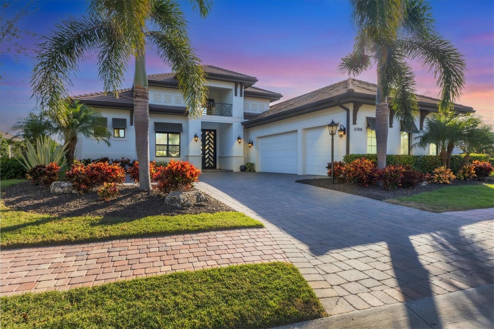 Welcome to Madison II, a former model home by Stock Signature Homes, positioned on an oversized, south-facing lakefront homesite. This stunning home blends luxury, design and functionality, offering an ideal setting for those seeking sophisticated living and a private lakeside retreat. As you enter through the custom 10-foot modern iron double doors, you are immediately greeted by an expansive, open floor plan bathed in natural light. The great room features soaring volume ceilings with elegant tray details, two sets of sliders opening to the spacious lanai and a seamless indoor-outdoor living experience. The heart of the home is the light and bright kitchen, designed for style and function. It boasts an oversized island, soft-close cabinetry, a walk-in pantry and top-of-the-line stainless steel appliances, making it a dream space for cooking and entertaining. The generous dining area provides the ideal setting for family meals or gatherings with friends. The home offers four spacious bedrooms, each with its own en-suite bath and ample closet space. The primary suite is a retreat, with dual walk-in closets, French door access to the lanai, plantation shutters and a tray ceiling. The luxurious primary bath features dual vanities, quartz countertops, a walk-in shower and a freestanding clawfoot soaking tub. The oversized fourth bedroom, with sliders to the lanai and a dedicated pool bath, can easily function as a bonus room or guest suite. The home office, just off the main living area, is designed for functionality and elegance, featuring glass French doors and engineered wood flooring, an ideal space for today’s remote lifestyle. Step outside to the expansive covered lanai, which is ideal for outdoor living and entertaining. The custom outdoor kitchen, complete with a built-in grill, vent hood, beverage cooler and access to the pool bath, makes this space ideal for hosting guests. The private lanai is an oasis, featuring a custom-built heated pool and spa, surrounded by lush, private landscaping. An extended air conditioned three-car garage with epoxy flooring offers plenty of room for storage or your favorite toys. The large laundry room is equipped with a utility sink and ample storage space for added convenience. Throughout the home, you’ll find high-end finishes and upgrades, including hurricane-impact glass and natural gas, ensuring comfort and security. Country Club East residents enjoy exclusive access to The Retreat, a neighborhood amenity center boasting a resort-style pool, fitness center and billiards room. Additionally, The Residents Club offers another pool, spa and a volleyball court for residents to indulge in leisure and recreation. For those seeking even more recreational options, just a few streets away lies the Lakewood Ranch Golf & Country Club, featuring 54 holes of golf, 20 Har-Tru tennis courts, multiple pools, and The Lodge bar and restaurant. Residents have the option to avail themselves of these facilities through various membership packages. Discover this gem in Lakewood Ranch, America’s top best-selling planned multigenerational community.