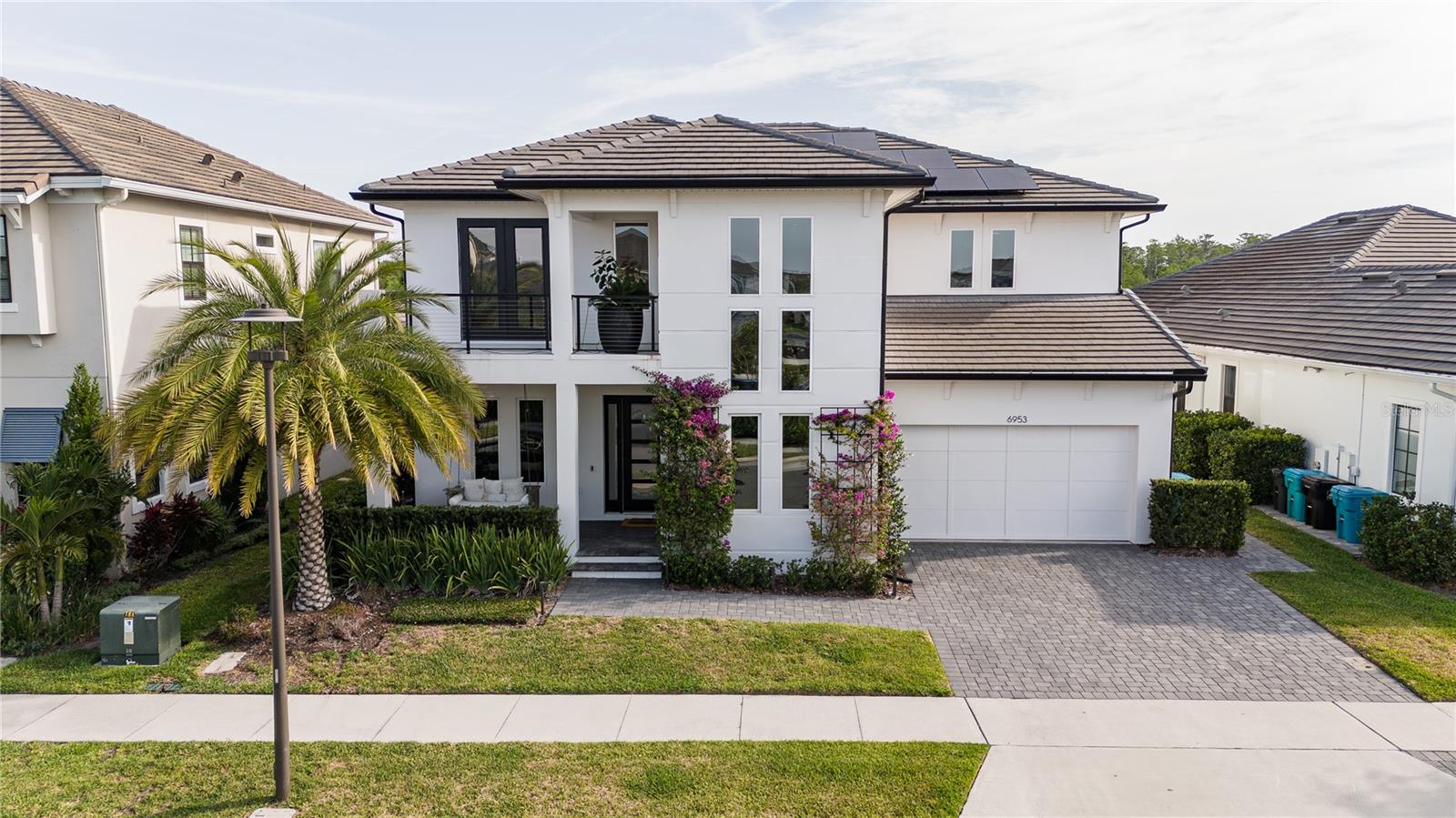 Get ready to fall in love with this incredible 4-bedroom, 3.5-bathroom home located in the heart of Laureate Park, Lake Nona’s premier community known for its lifestyle, location, and luxury. From the moment you pull into the extended driveway and take in the home’s striking curb appeal, it’s clear this one is something special. Perfectly situated on an oversized 8,840 sq. ft. lot, this home features thoughtful upgrades throughout, from professionally sealed pavers and a hidden trash enclosure to custom landscape lighting and built-in holiday lights ready for every season. The design is as functional as it is beautiful, offering the perfect balance between upscale living and everyday comfort. Inside, the open-concept floorplan is filled with natural light, soaring ceilings, and plenty of space to gather and unwind. A dedicated office sits just off the main living area and offers tall windows and a sense of airiness that makes working from home feel effortless. The chef’s kitchen is a dream, complete with Monogram appliances, a smart touchscreen fridge with hot water dispenser, a professional-grade cooktop, and a whole-house water filtration system with an added alkaline filter. The laundry area is just as impressive, featuring an additional high-end refrigerator, an LG washer with a built-in express mini-washer, and a premium dryer. Upstairs, the luxury vinyl flooring adds warmth and style, while the upgraded staircase and modern light fixtures elevate the entire space. The primary suite is a true retreat, with a large walk-in closet and a spa-inspired en-suite bath featuring dual vanities, a soaking tub, and a sleek frameless glass shower. Comfort meets practicality with dual-zone A/C systems, one for each floor, an energy-efficient water heater, and a hardwired security camera system with full recording capabilities. A touchless ceramic kitchen faucet, smart irrigation system, custom bamboo landscaping for added privacy, and brand-new backyard fencing all contribute to the home’s thoughtful and efficient design. Step outside into your private outdoor sanctuary, an entertainer’s paradise. The saltwater pool is surrounded by heat-resistant decking, while the covered pergola houses a full summer kitchen outfitted with a built-in beverage fridge, trash drawer, a smokeless touchscreen air grill, and a modern waterfall feature, all fully controlled from your smartphone. Premium synthetic turf, a four-hole putting green, designer patio furniture, and a cozy swing add the perfect finishing touches to this one-of-a-kind backyard escape. And yes, the golf cart is included! Whether you're heading to the neighborhood coffee shop, park, or community events, you can ride in comfort and style. To top it all off, the home is equipped with a cutting-edge solar panel system, providing significant energy savings and a more sustainable lifestyle. All of this is just minutes away from Lake Nona’s top-rated schools, medical facilities, shopping, dining, and some of Orlando’s best parks and entertainment. This home isn’t just a place to live, it’s a lifestyle. Schedule your private showing today and don’t miss out on everything this incredible property has to offer!