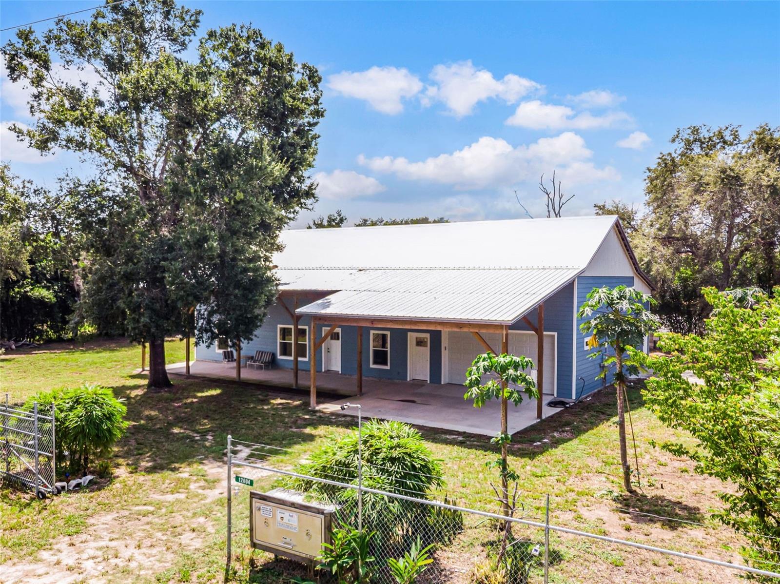 This spacious 2-bedroom 2 bath CUSTOM home sits on .65 acres nestled in the heart of Tavares, Florida. The home offers a blend of comfort and convenience. This unique property was built in 2024 using Insulated Concrete Forms (ICF), a construction system that provides an incredible combination of durability, strength and efficiency. ICF construction keeps the interior of this property warm in the winter and cool in the summer allowing your HVAC to operate at a minimum expense. LED lighting throughout the home contributes to further monthly savings. The Green Energy features of the home include the construction, insulation, windows and a dehumidifier system.
The spacious and oversized 2-car garage harbors an overhead Lift Master that is incredibly smooth and quiet with an auto locking feature for added security. There is also an additional storage room behind the garage that could be used as a workshop and/or storage for lawn equipment. Access to the 2nd level, which is under air, is through the garage via a 4’ wide staircase (no rickety pull-down stairs here) with subfloors over steel joists. The locally manufactured roof trusses are made of roll formed steel. There is no fiberglass insulation to worry about in this area either as the roof is insulated with closed cell foam further contributing to the efficiency of this property. In addition to storage, this area could also be used as a bonus or a media room. It’s a blank canvas for your imagination.
The exterior is clad with shiplap Crete board and painted in a beautiful Williamsburg blue with a light trim. Located in the front and rear of the home are tall open porches ready for relaxation. The property is completely fenced and has a private security gate. Another security feature installed is the 3-Point Deadbolt Locking System on all the exterior doors.
The interior of the home features 10’ ceilings throughout, a kitchen with 3’ wooden cabinets, a solid butcher block countertop, along with a Whirlpool stainless steel package. The primary bedroom is spacious and has 2 walk-in closets. Enter the primary bathroom and discover a large walk-in shower that hosts an incredible Rain Showerhead.
Don’t miss this opportunity to make this unique house your new home!